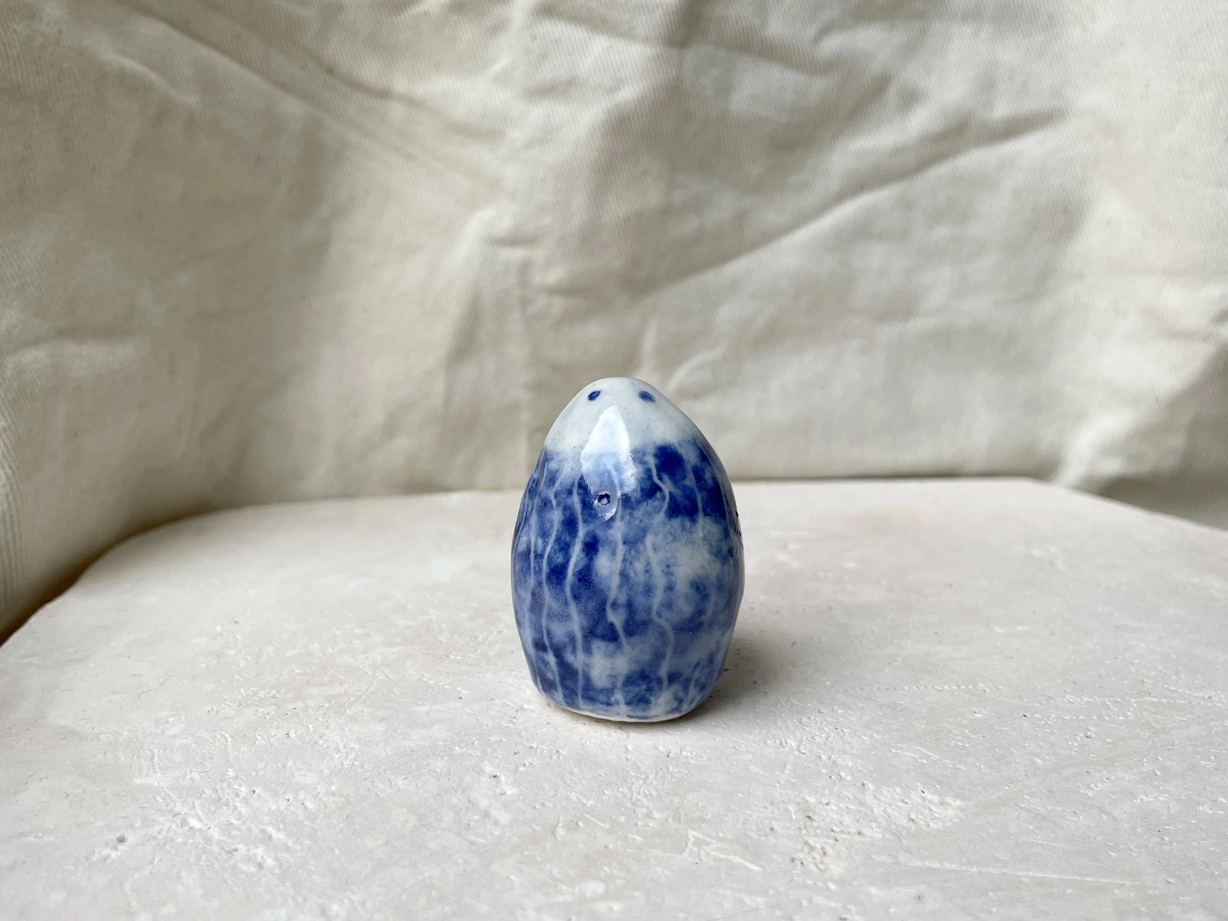 White and blue glossy dotty handmade figurative ceramic sculpture