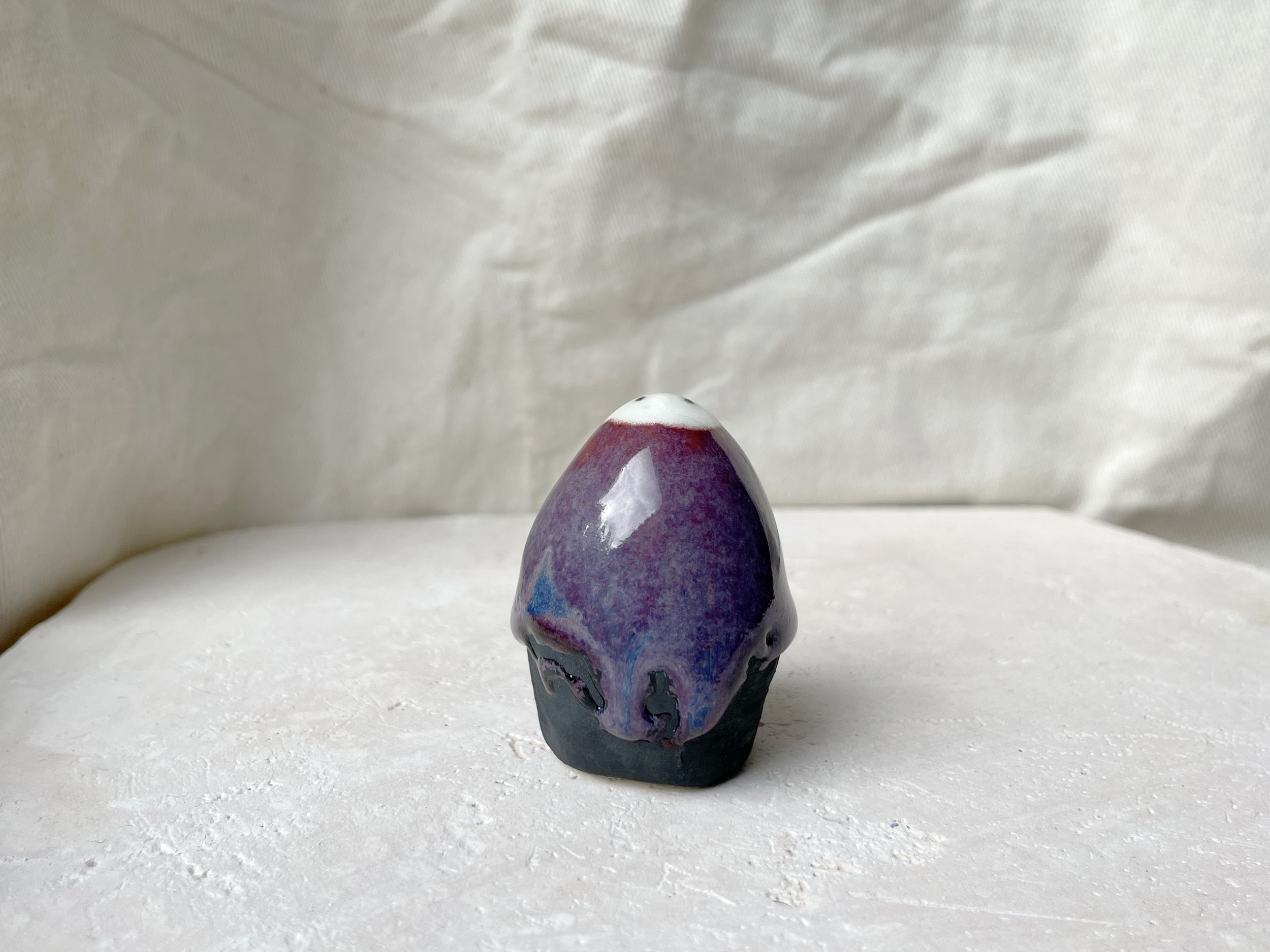 purple, black, blue handmade figurative ceramic sculpture with glossy floating glaze