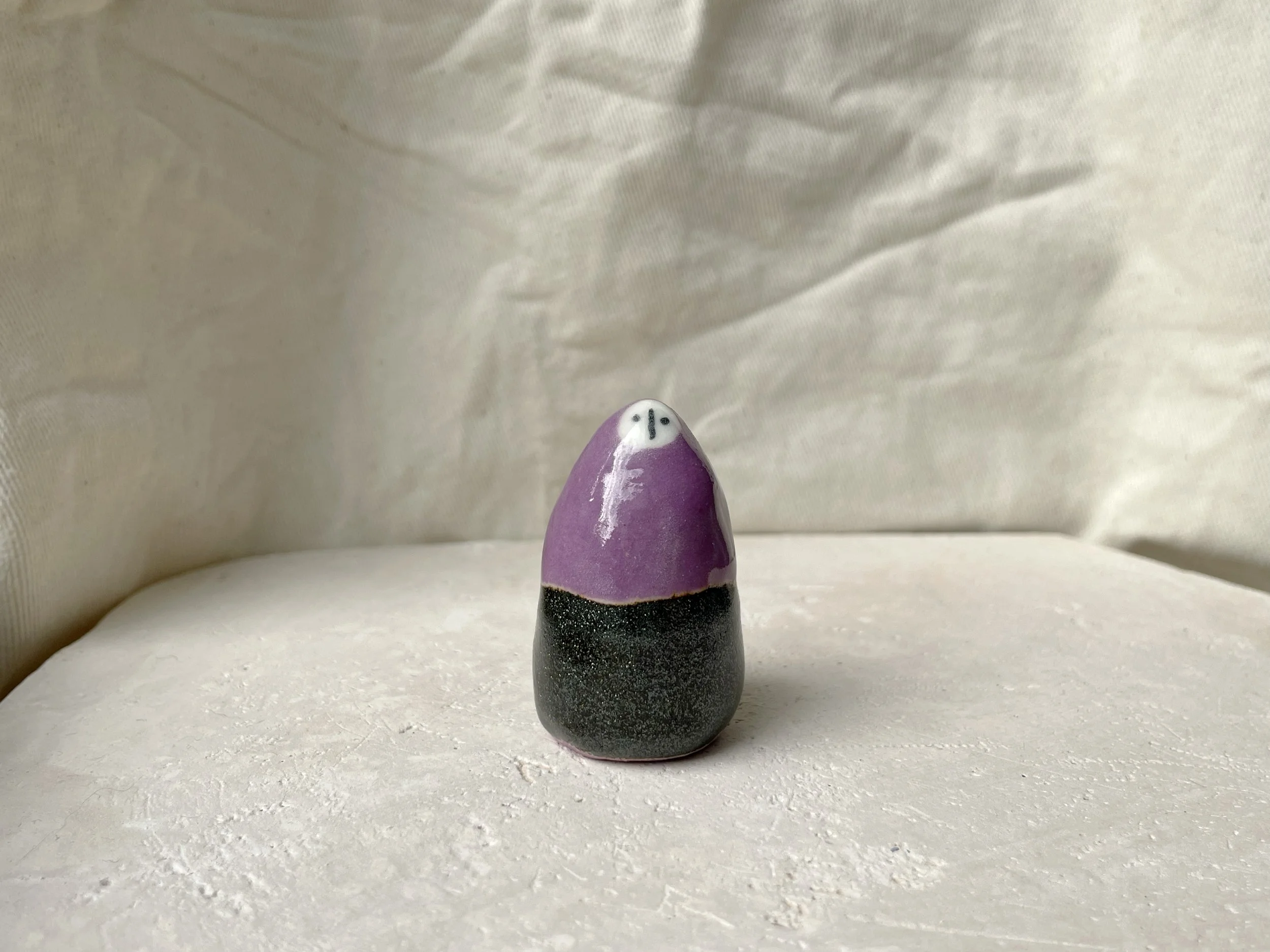 Purple and sparkly black handmade figurative ceramic sculpture with underglaze and glaze