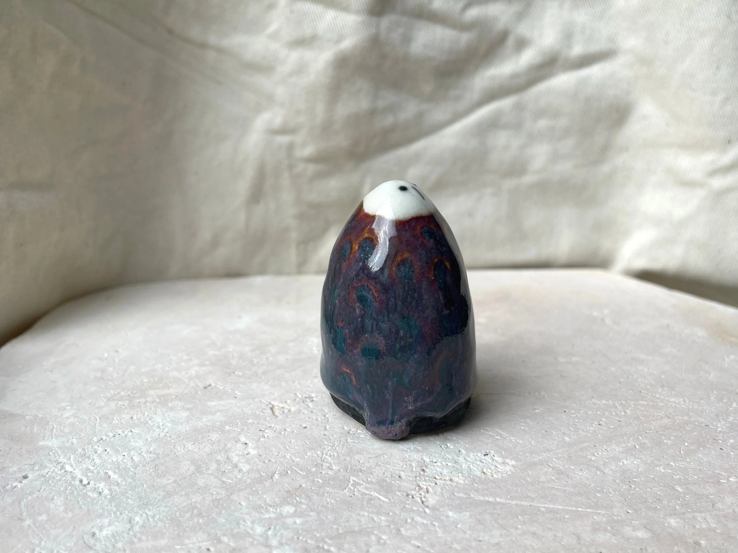 Purple, black and red handmade figurative ceramic sculpture with underglaze and floating glaze