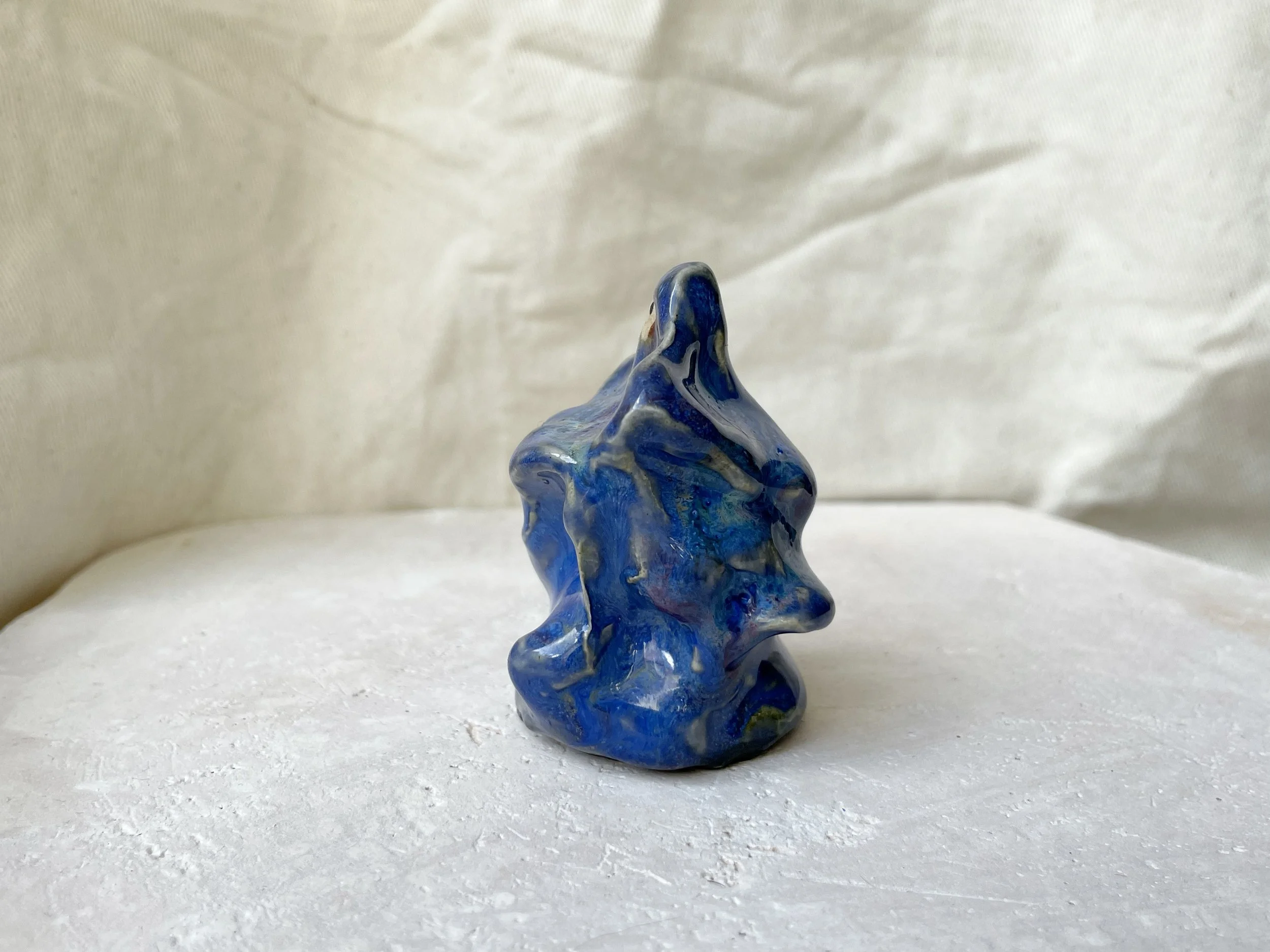 blue wavey handmade figurative ceramic sculpture with runny glaze