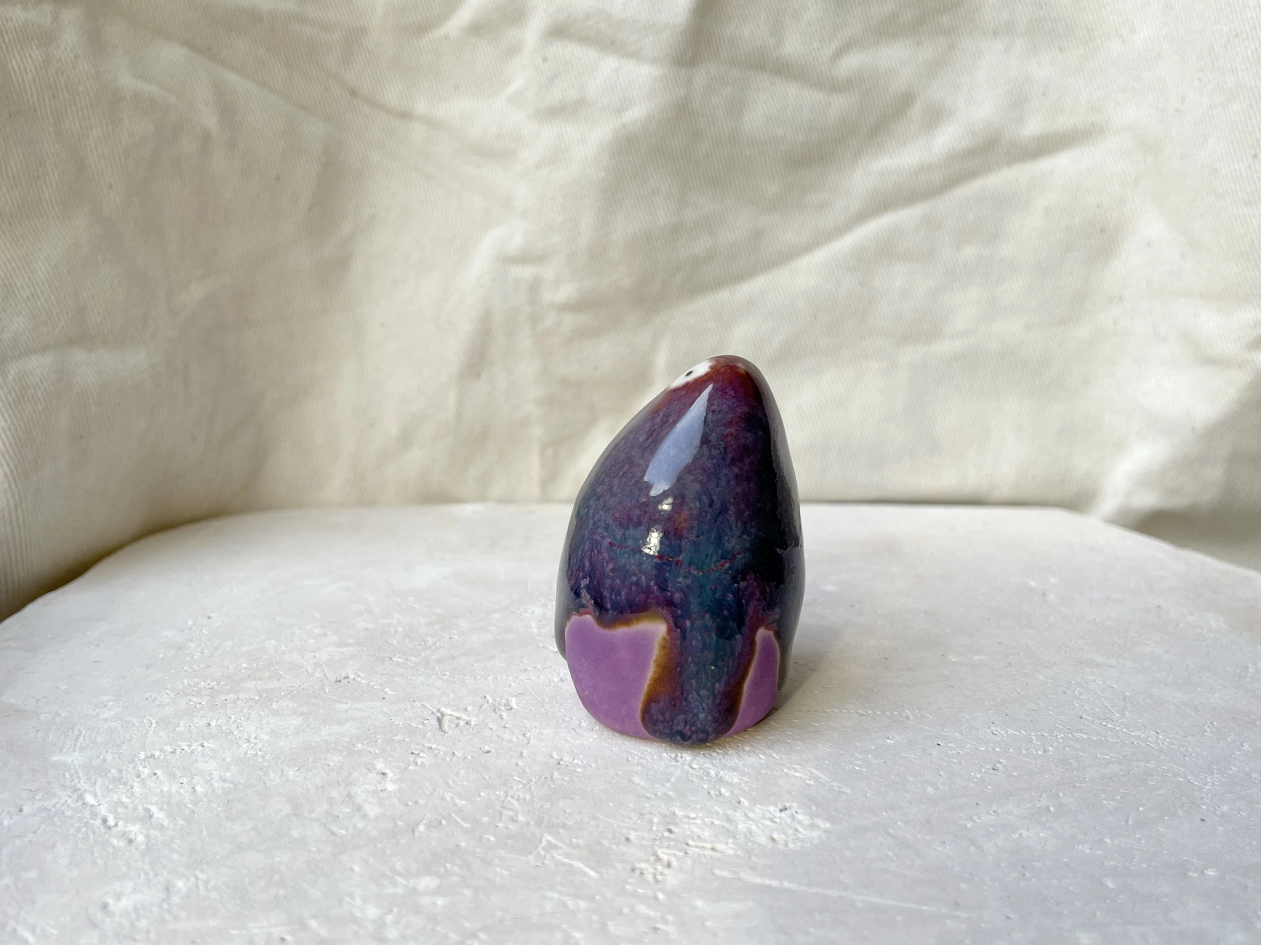 Purple, lilac and red handmade figurative ceramic sculpture with glossy drippy glaze