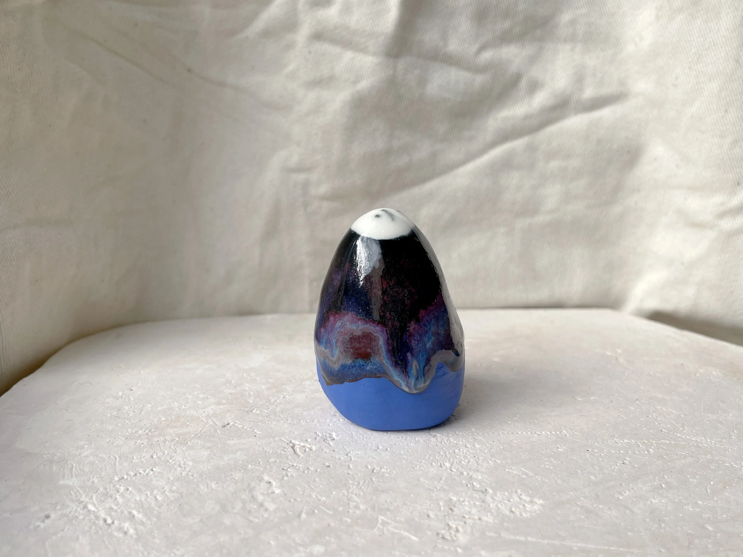 purple, blue, black and red handmade figurative ceramic sculpture with glossy drippy floating glaze