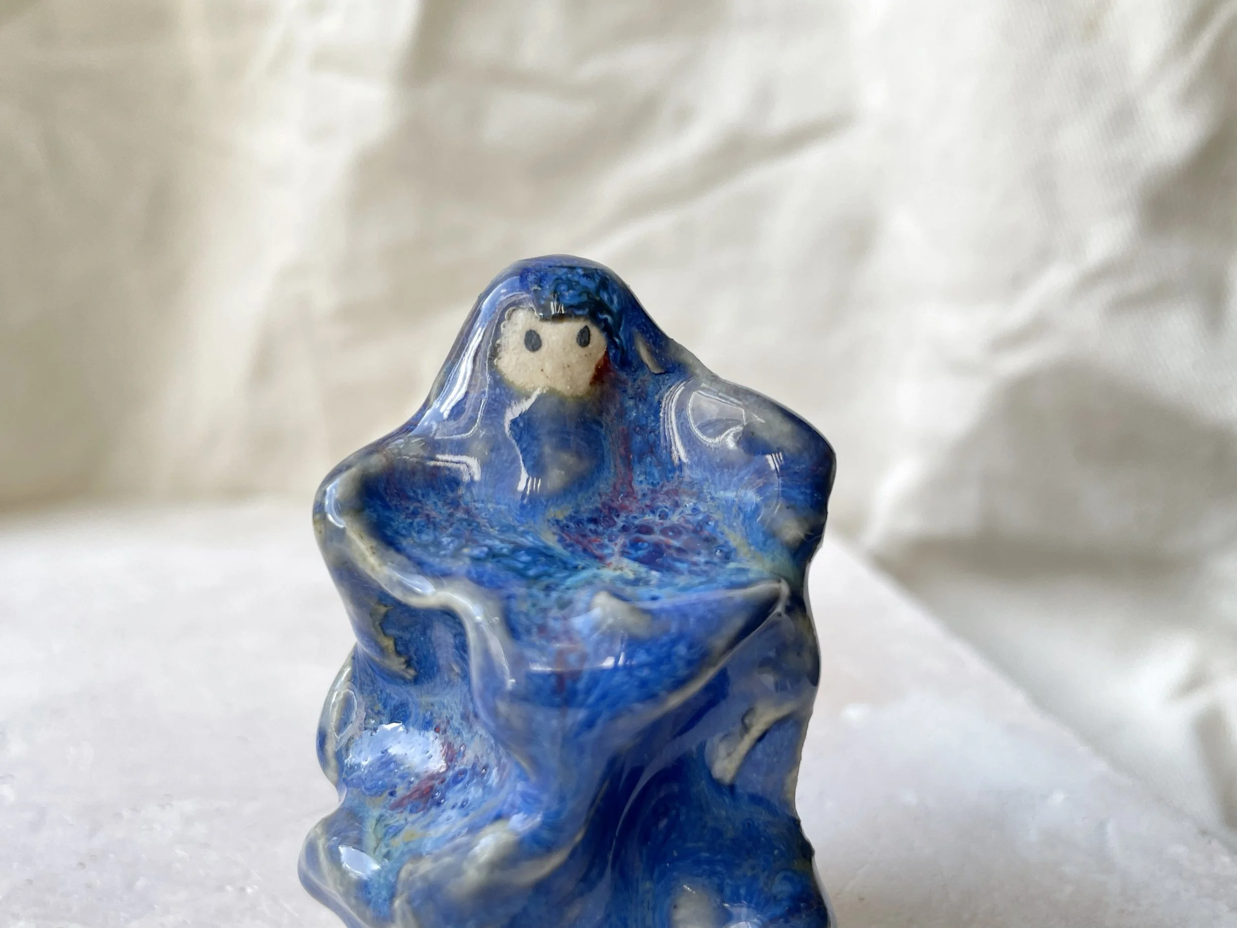 blue wavey handmade figurative ceramic sculpture with runny glaze