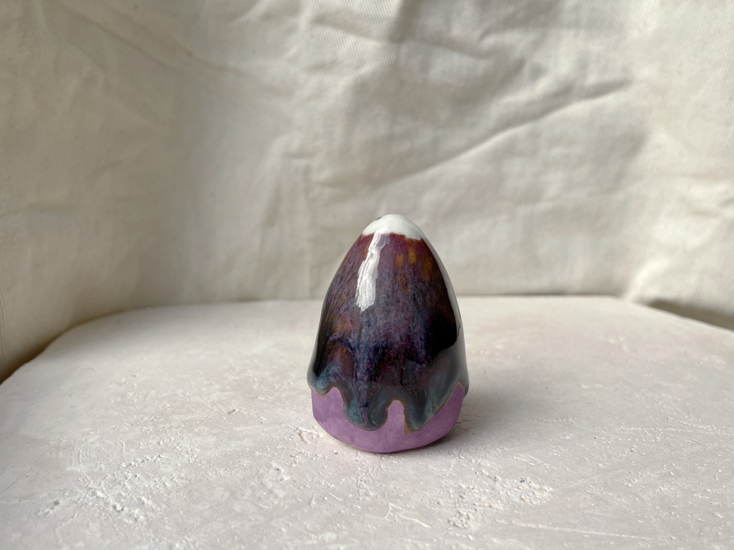 blue, orange, purple and red handmade figurative ceramic sculpture with glossy drippy floating glaze
