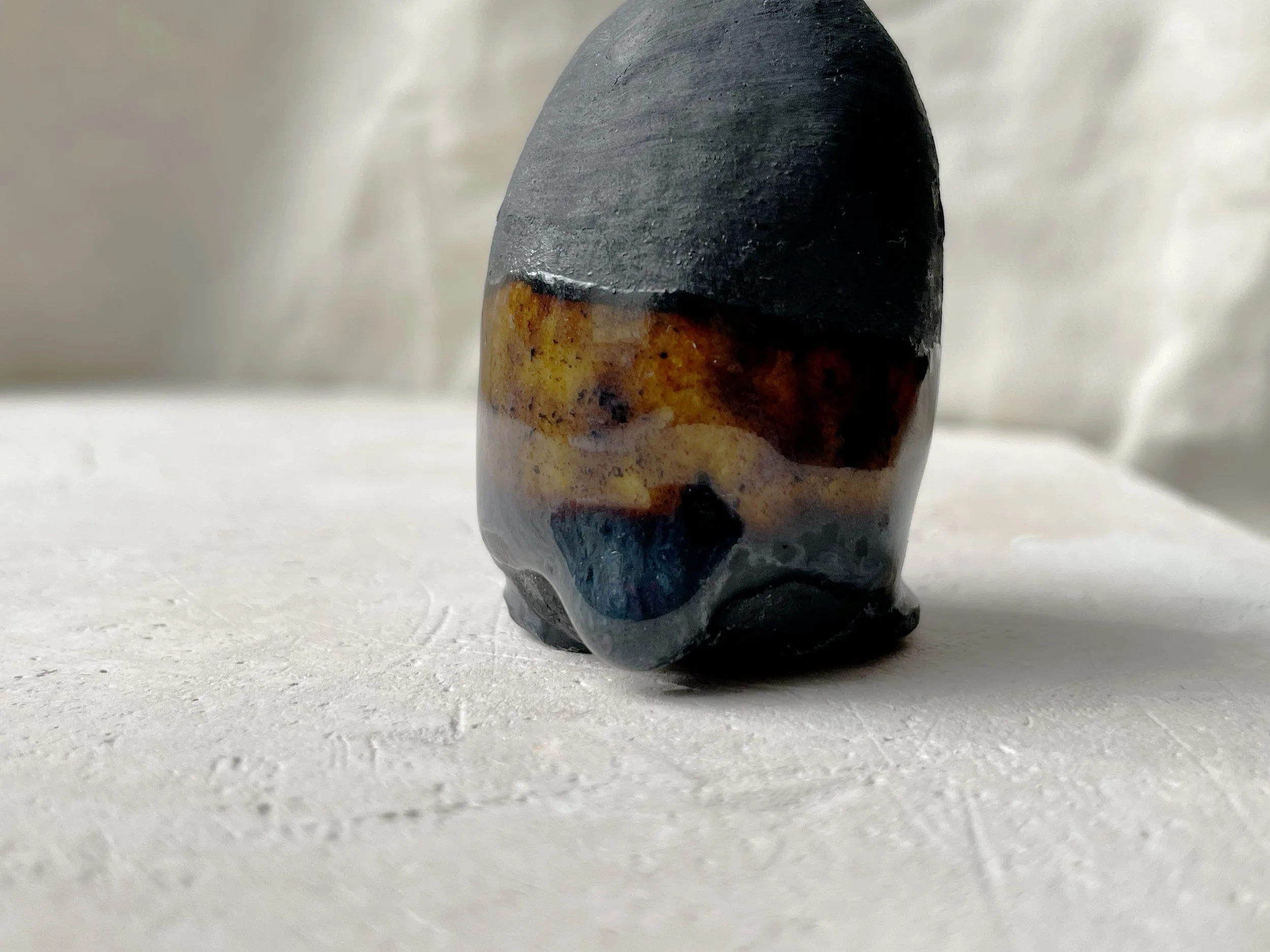 black and brown handmade figurative ceramic sculpture with matt and runny glaze