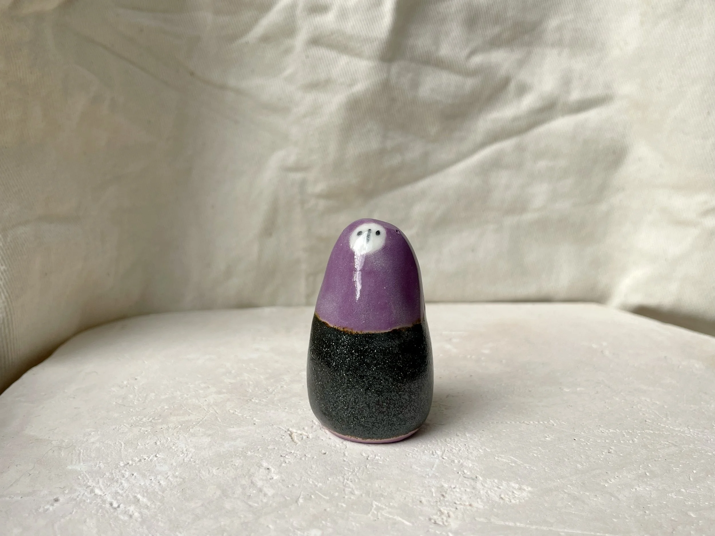 Purple and sparkly black handmade figurative ceramic sculpture with underglaze and glaze