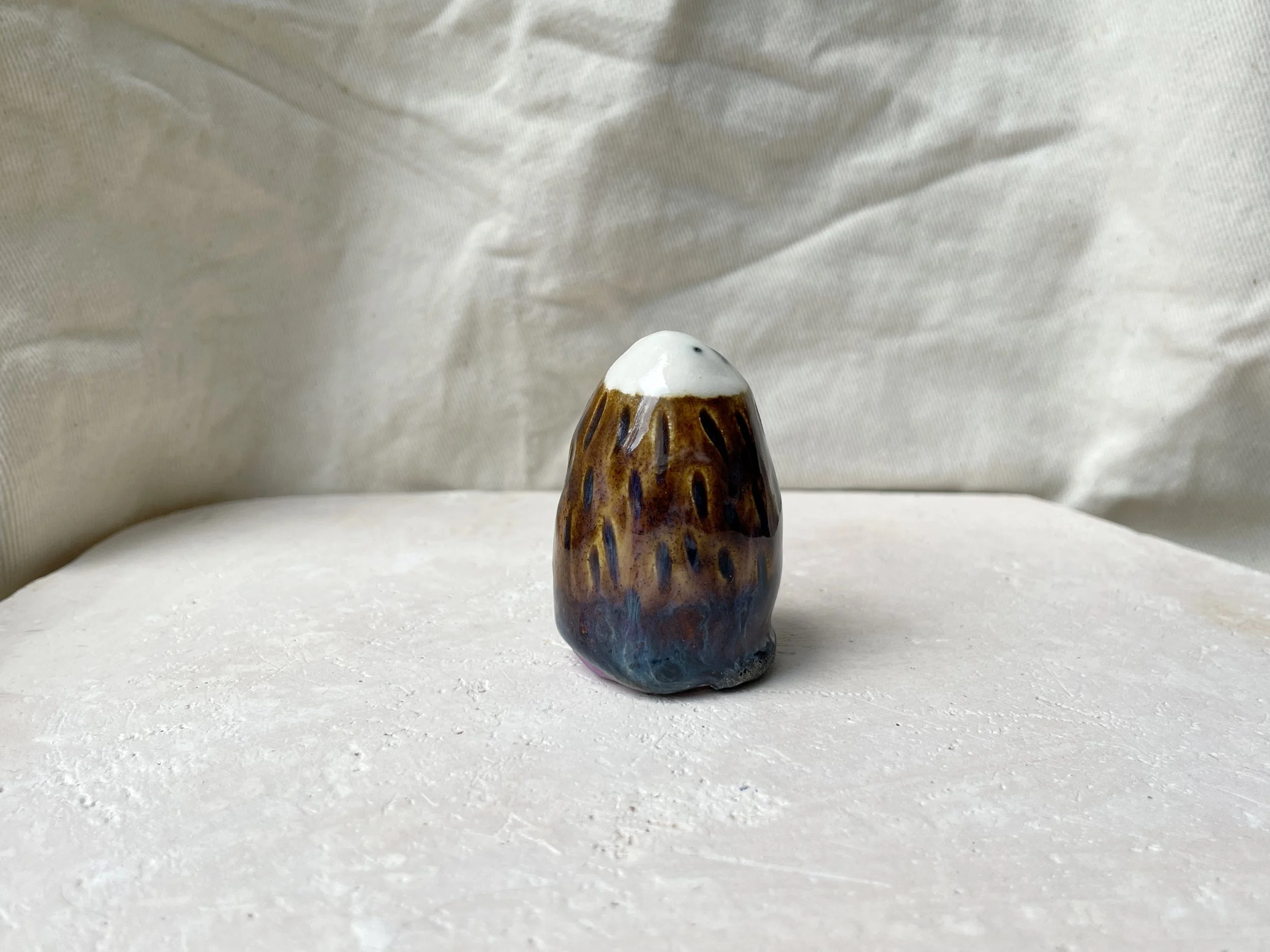 brown, purple and blue handmade figurative ceramic sculpture with underglaze and drippy float glaze
