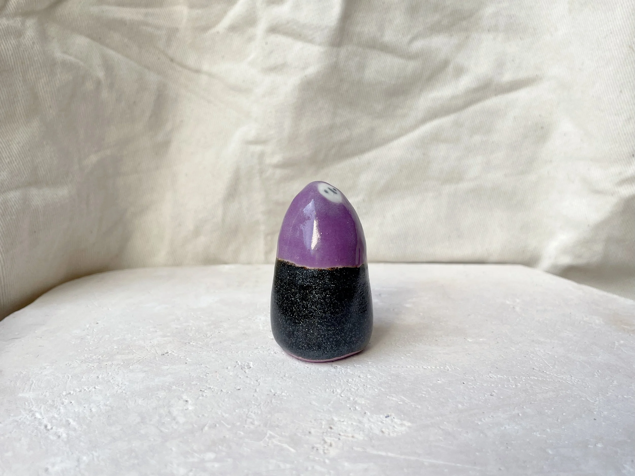 Purple and black sparkly handmade figurative ceramic sculpture with glittery glaze