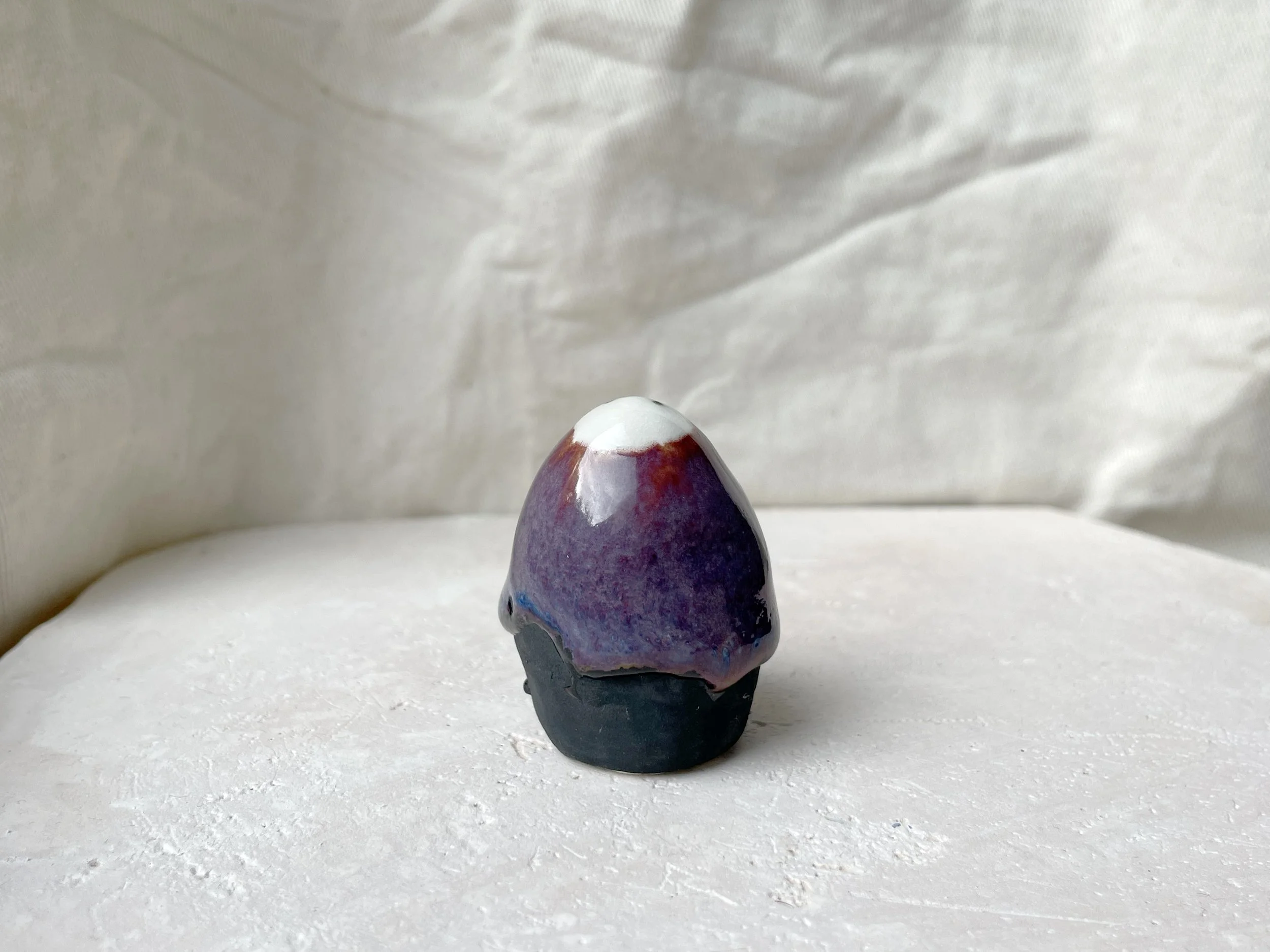 purple, black, blue handmade figurative ceramic sculpture with glossy floating glaze