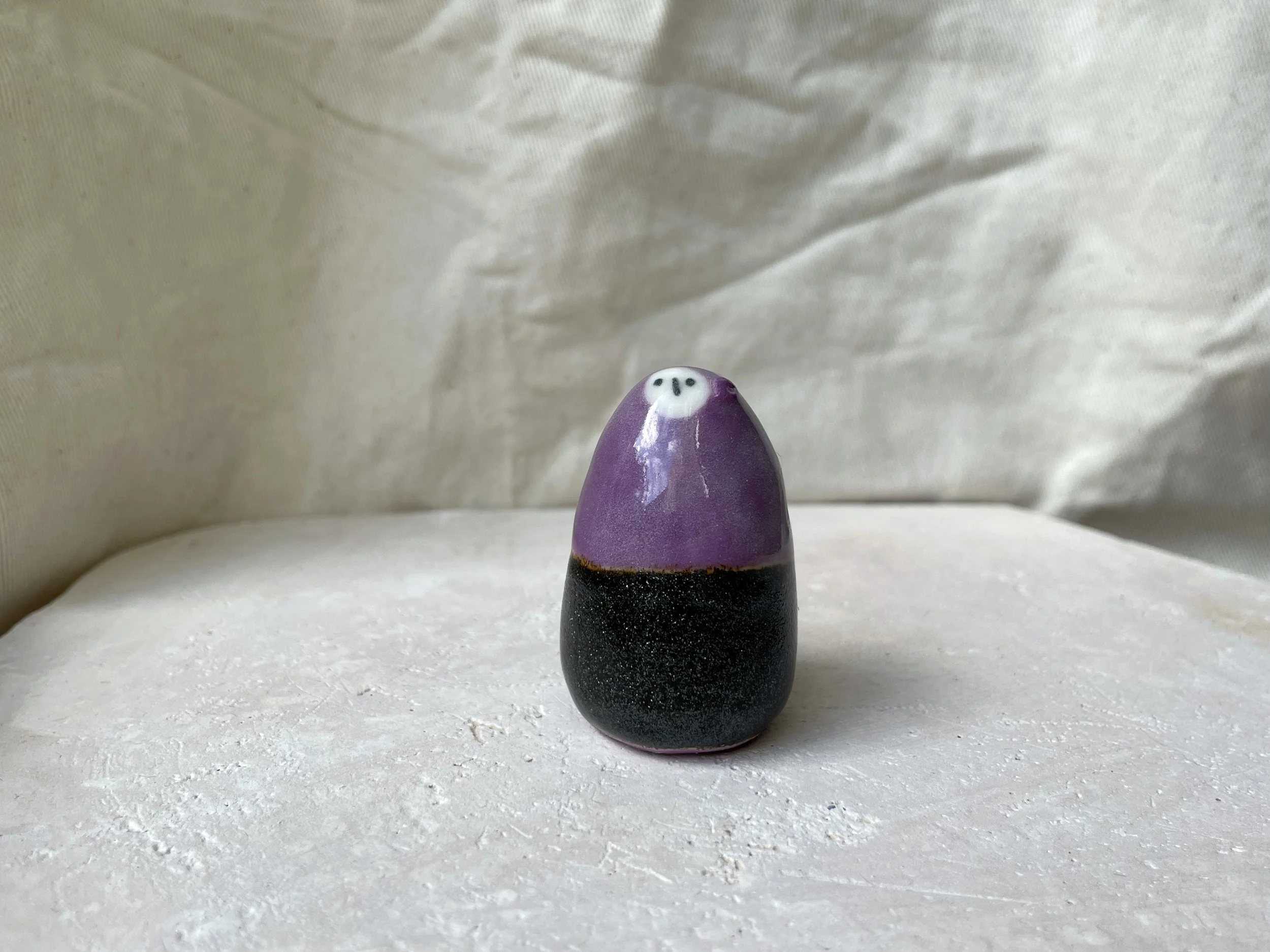 black and purple handmade figurative ceramic sculpture with sparkling cosmic glaze