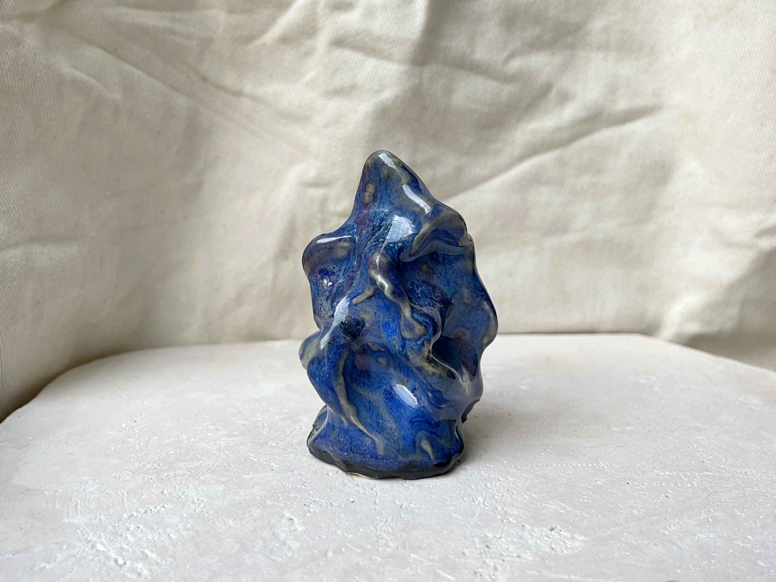 Wavy blue and red handmade figurative ceramic sculpture with glossy floating glaze and underglaze