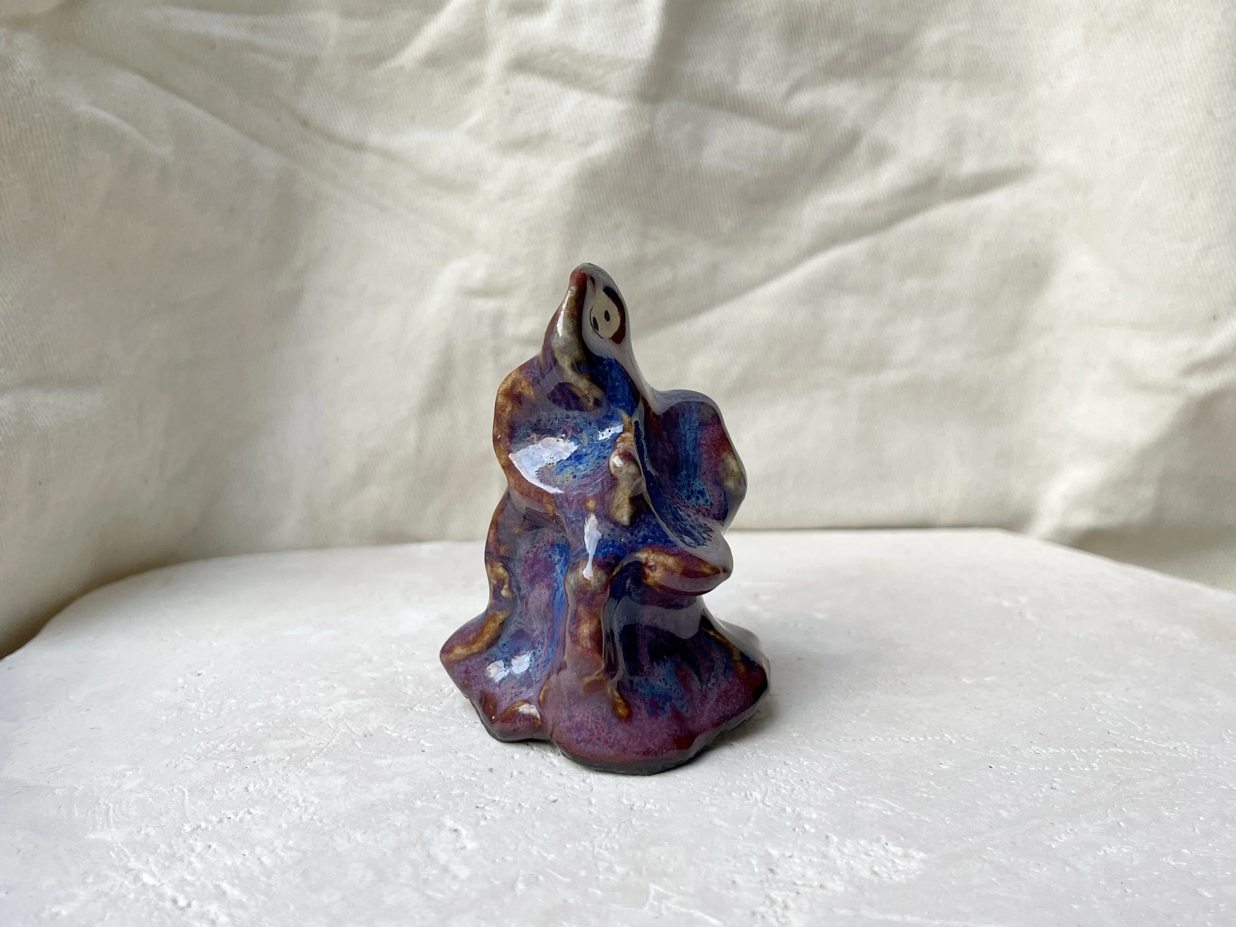Wavy purple, red and blue handmade figurative ceramic sculpture with glossy floating glaze and underglaze