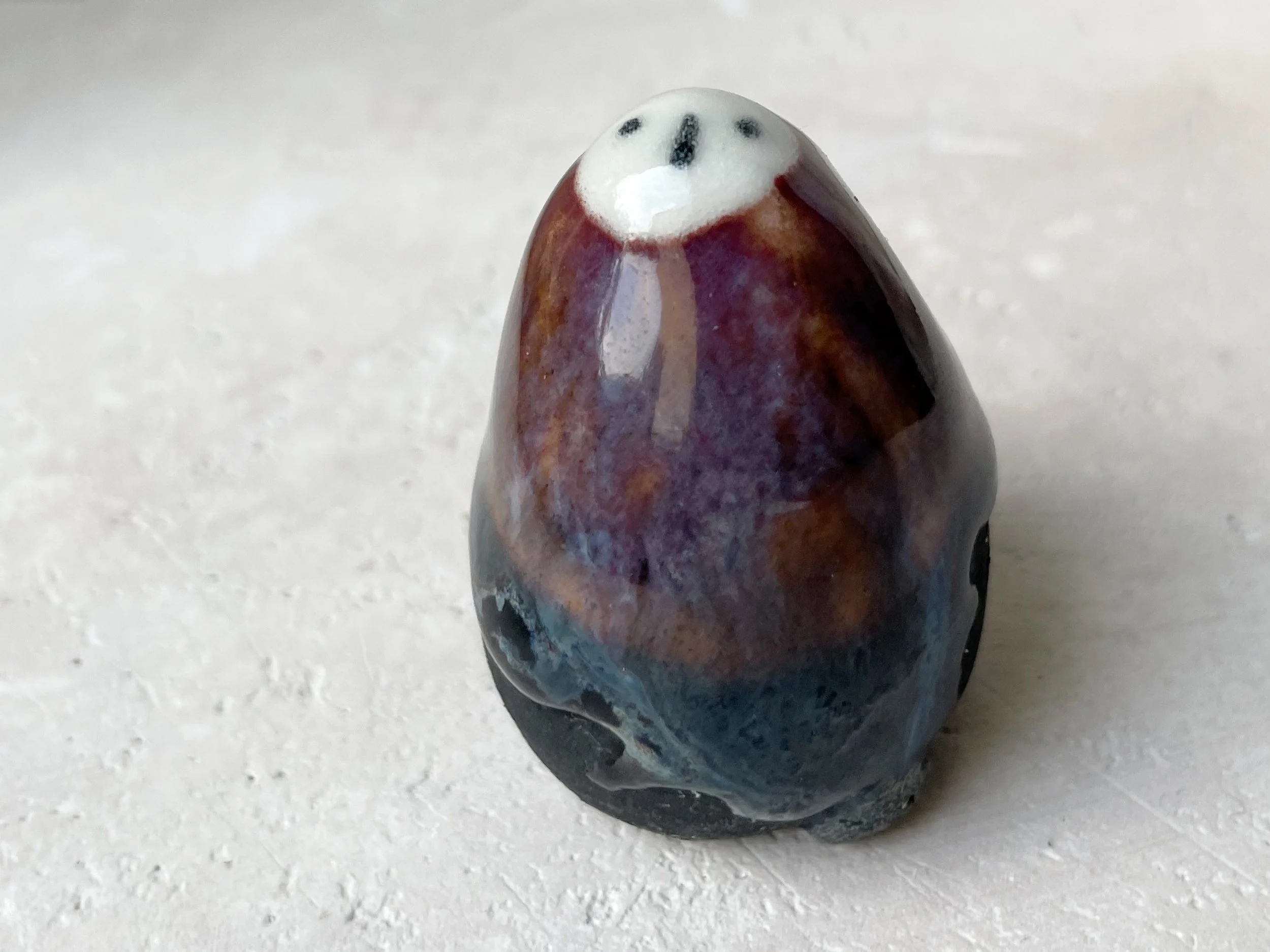 Blue, orange, purple and black handmade figurative ceramic sculpture with underglaze and drippy float glaze