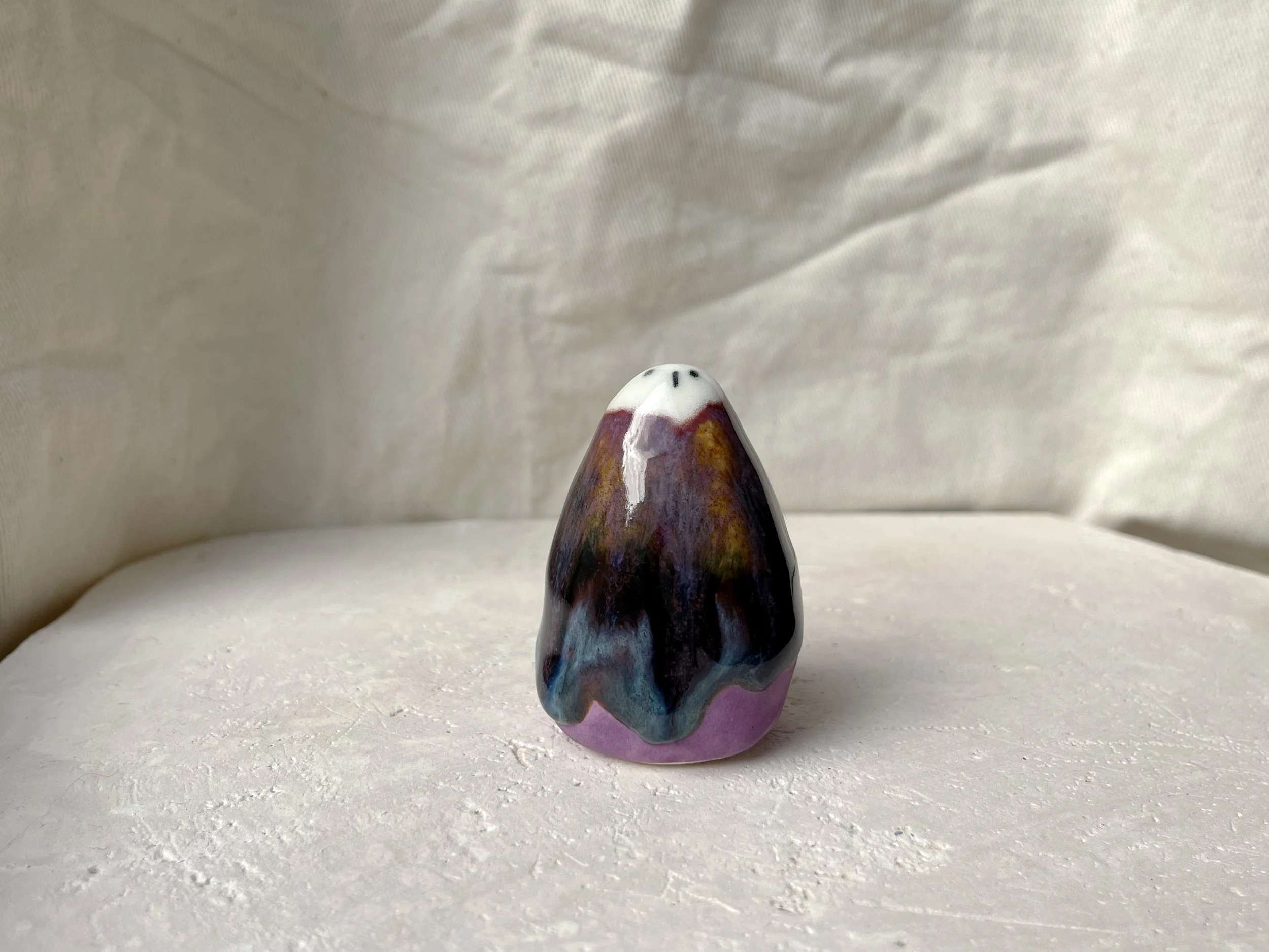 blue, orange, purple and red handmade figurative ceramic sculpture with glossy drippy floating glaze