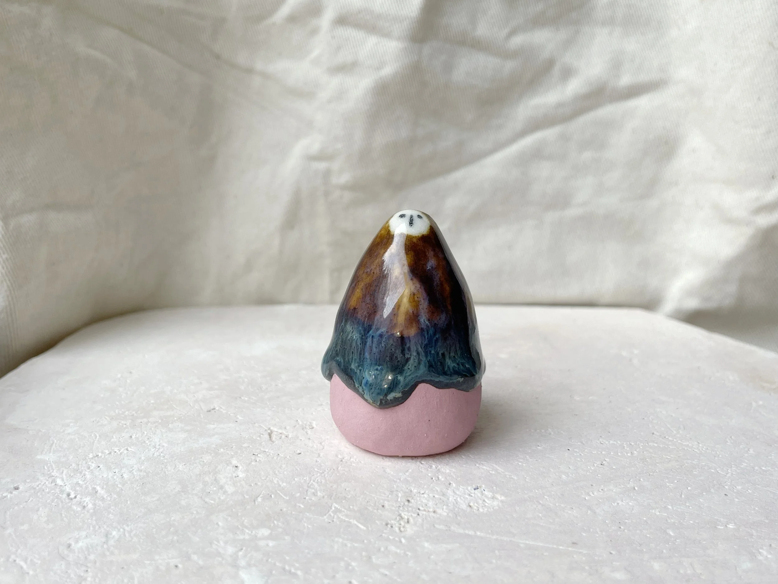 pink, brown and green handmade figurative ceramic sculpture with underglaze and drippy runny glaze