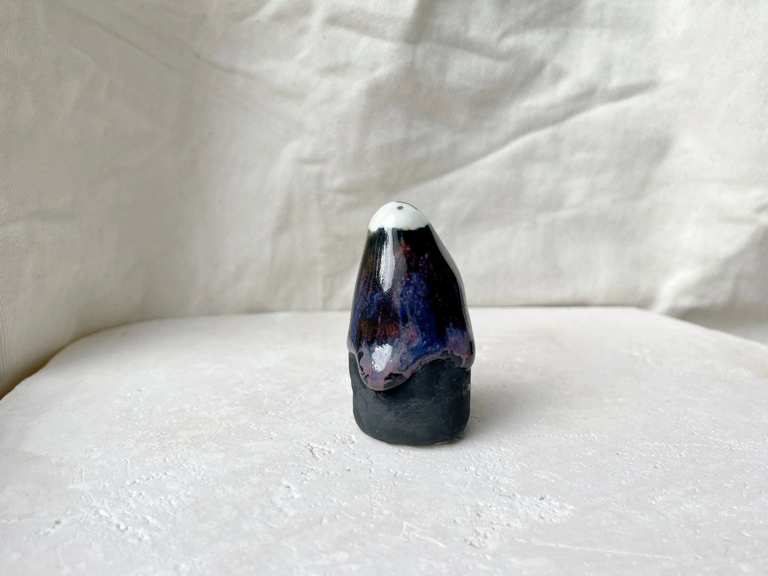 black, lilac and purple drippy handmade figurative ceramic sculpture with glossy floating glaze