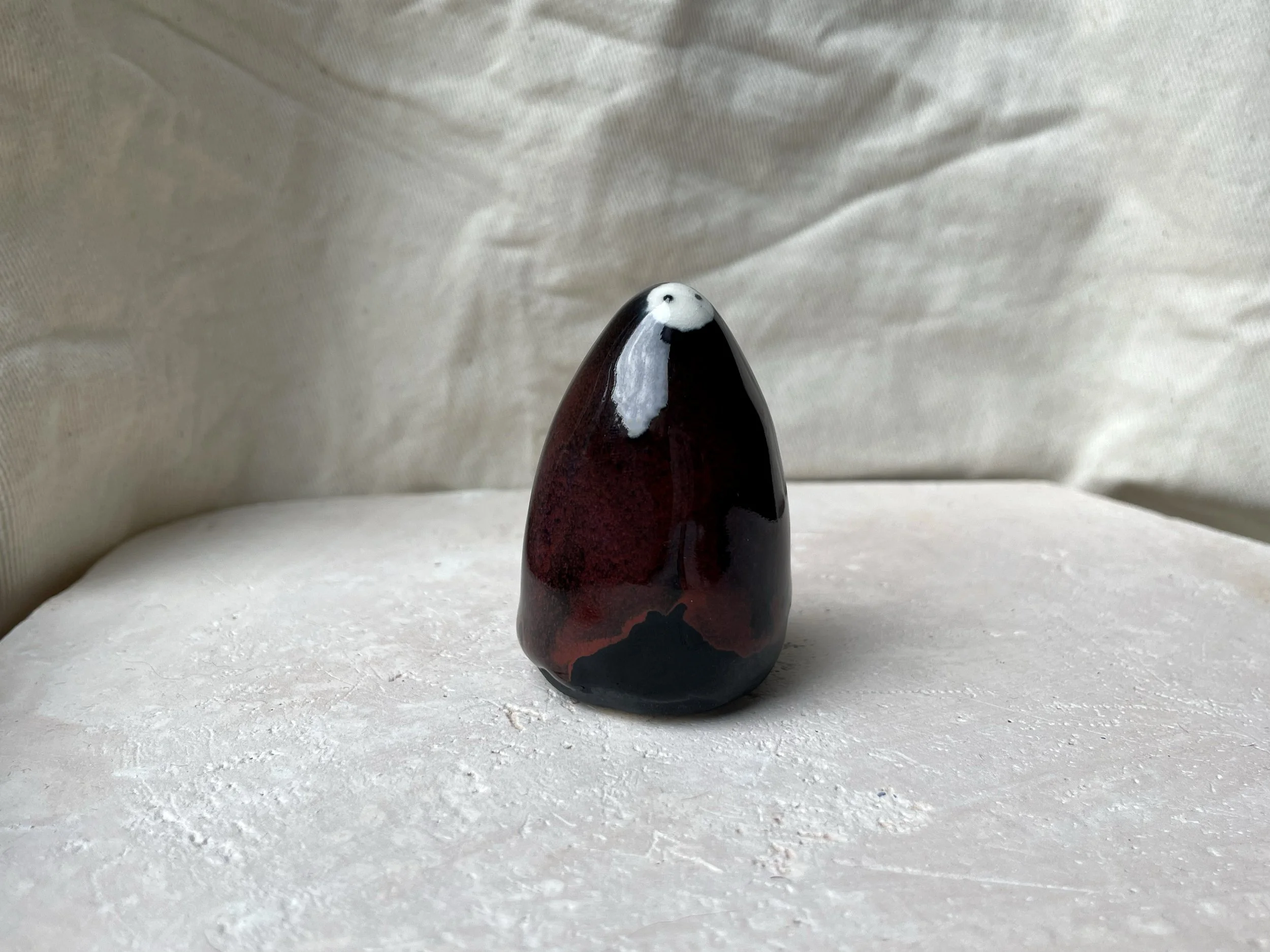 black and red handmade figurative ceramic sculpture with underglaze and floating glaze