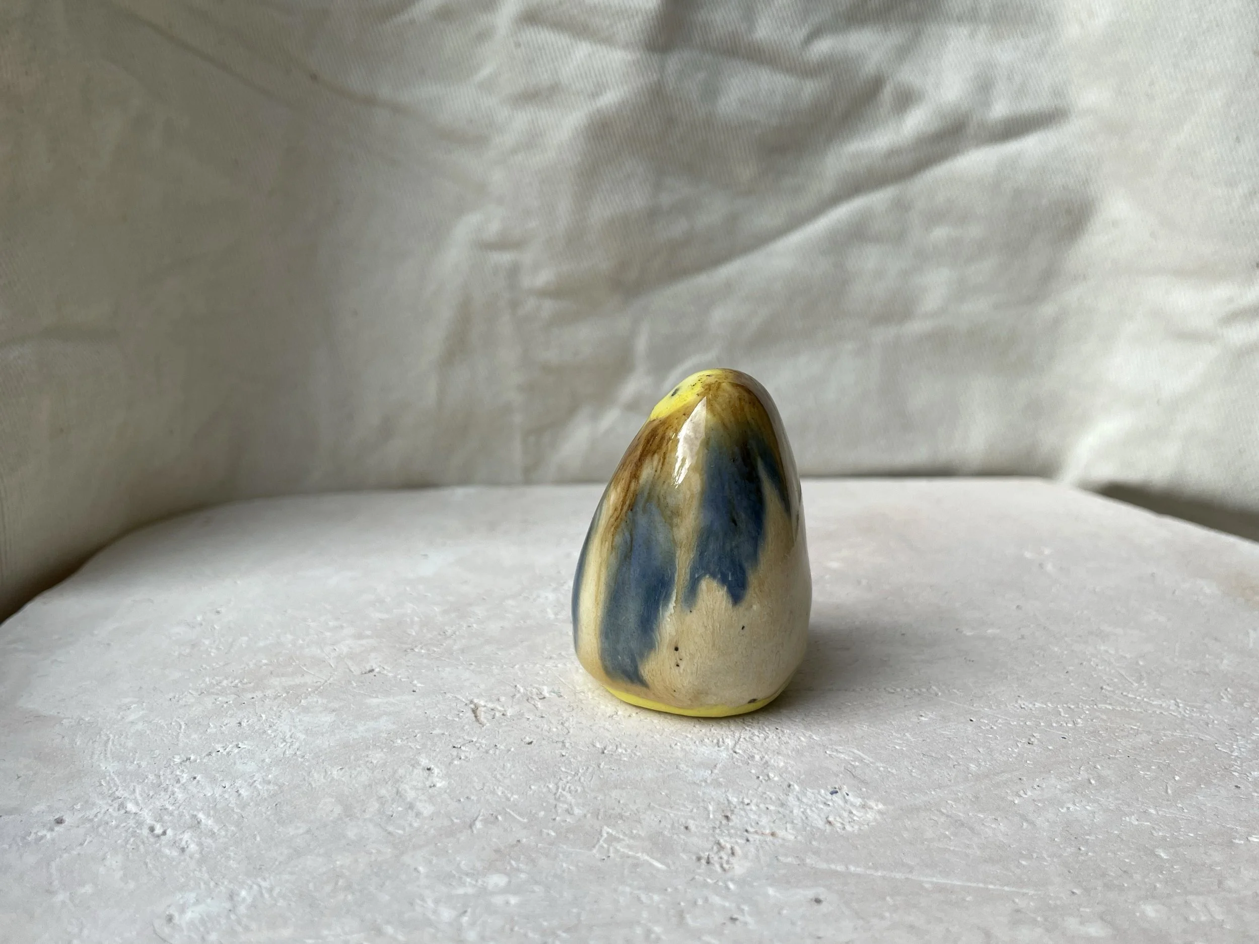 Yellow, brown, blue and cream handmade figurative ceramic sculpture with glossy drippy glaze