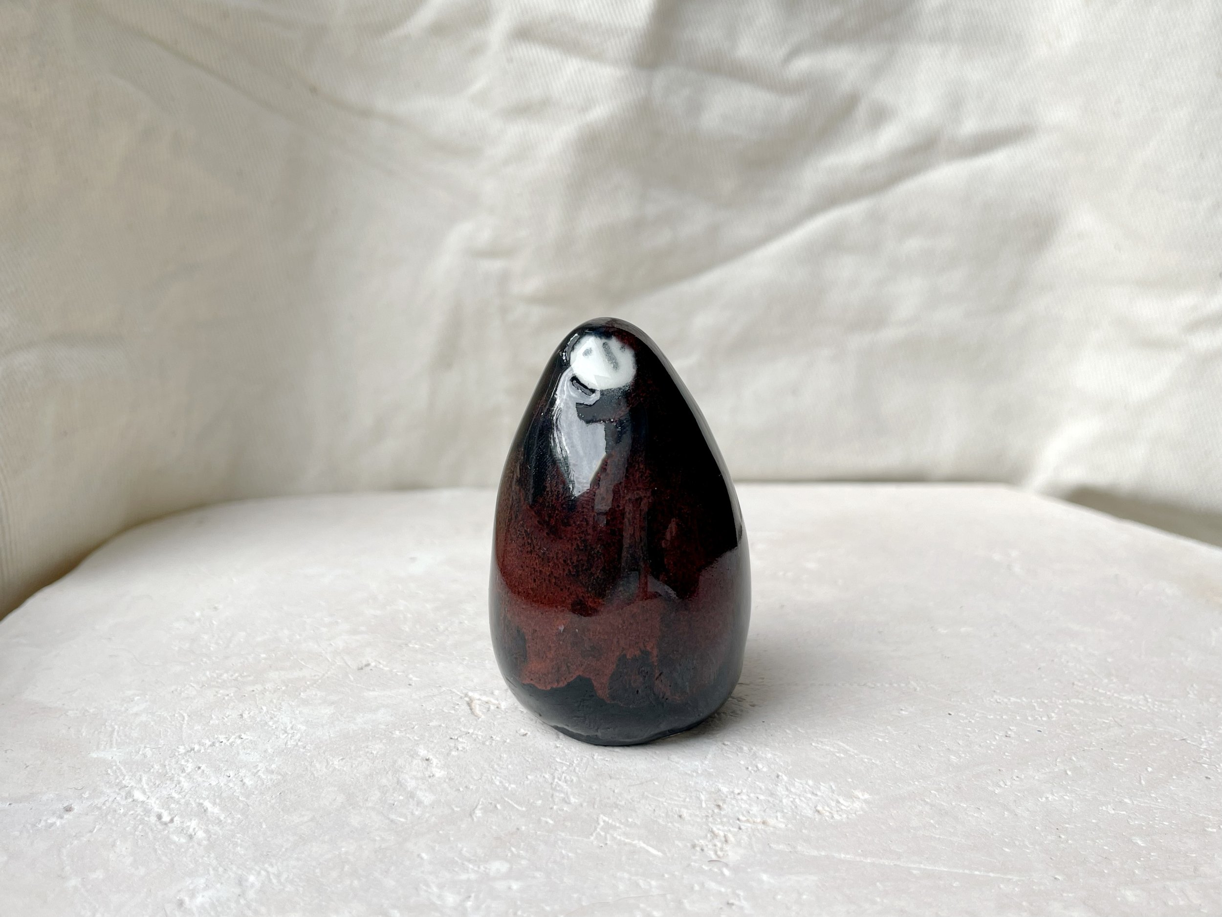 black and red handmade figurative ceramic sculpture with underglaze and floating glaze