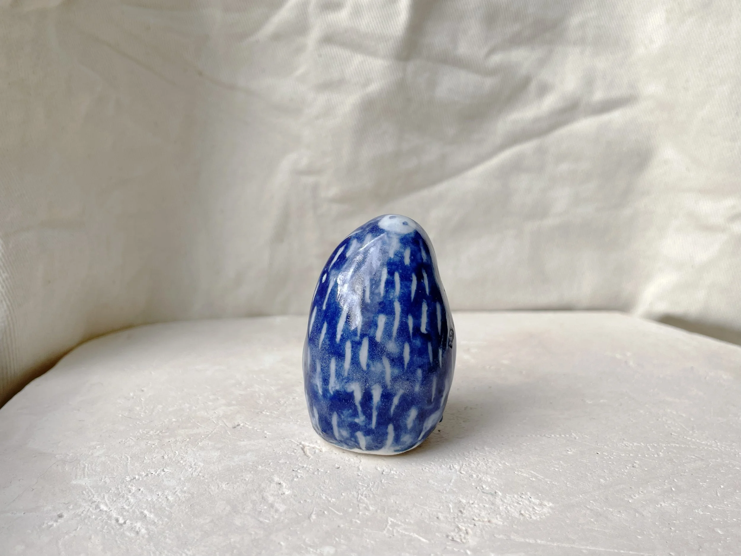 blue and white handmade figurative ceramic sculpture with cobalt oxide and glaze