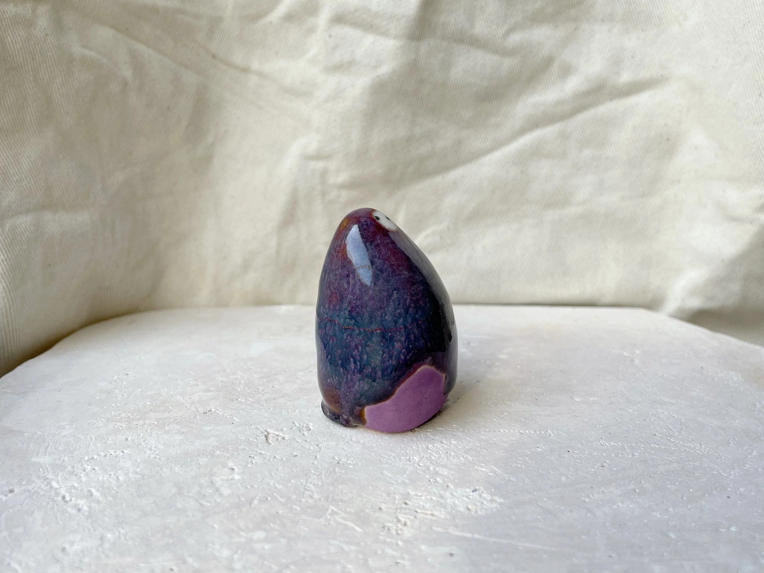 Purple, lilac and red handmade figurative ceramic sculpture with glossy drippy glaze