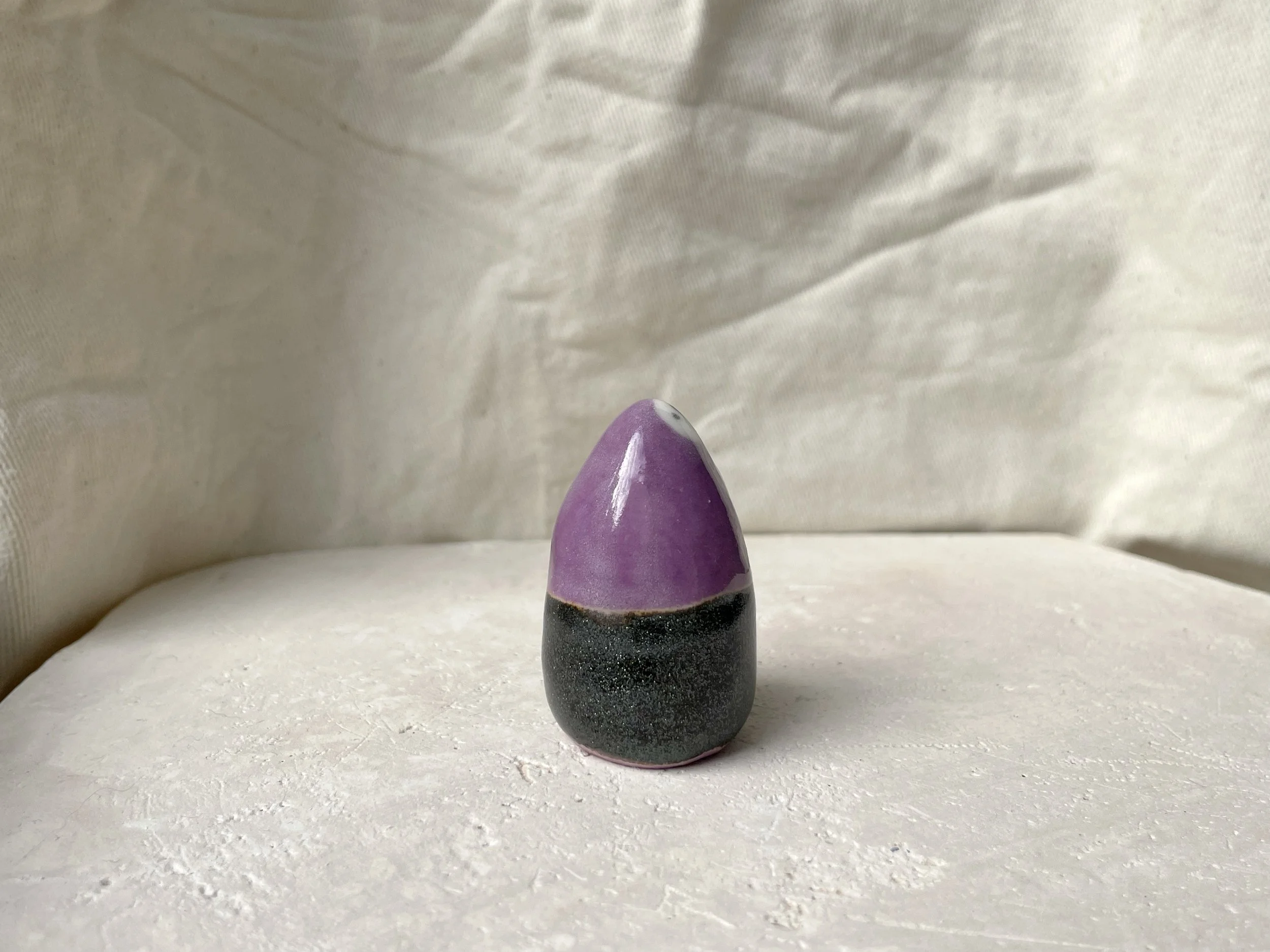 Purple and sparkly black handmade figurative ceramic sculpture with underglaze and glaze