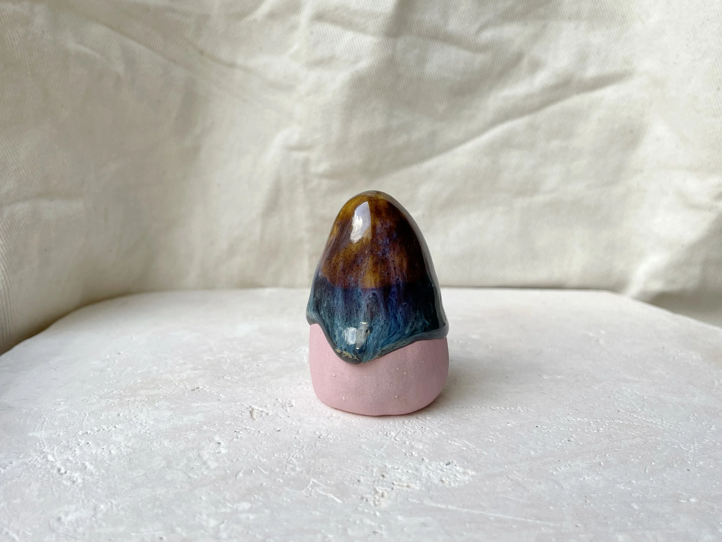 Pink, brown and green and cream handmade figurative ceramic sculpture with glossy drippy glaze