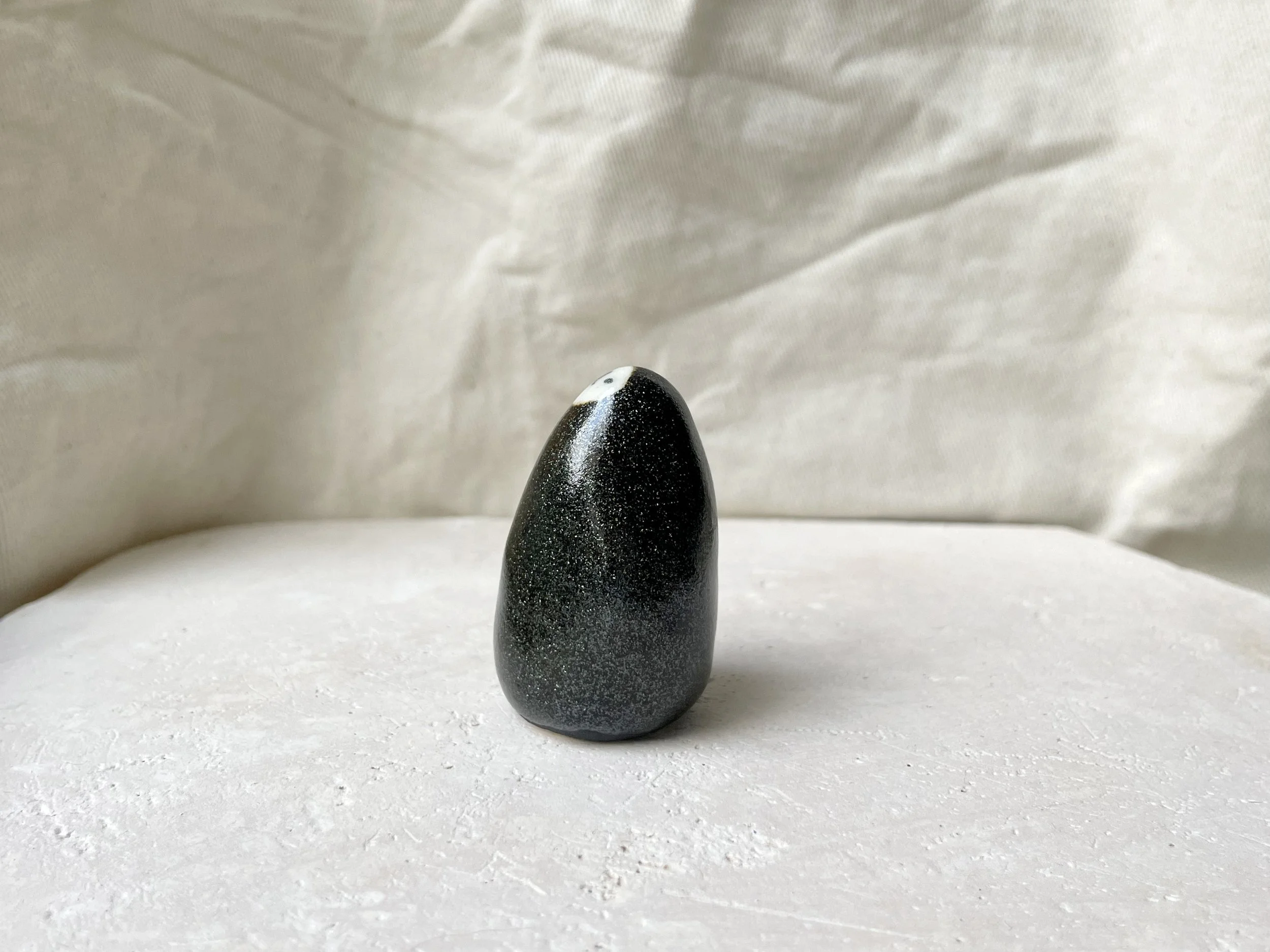 Black and white sparkly handmade figurative ceramic sculpture with glittery glaze
