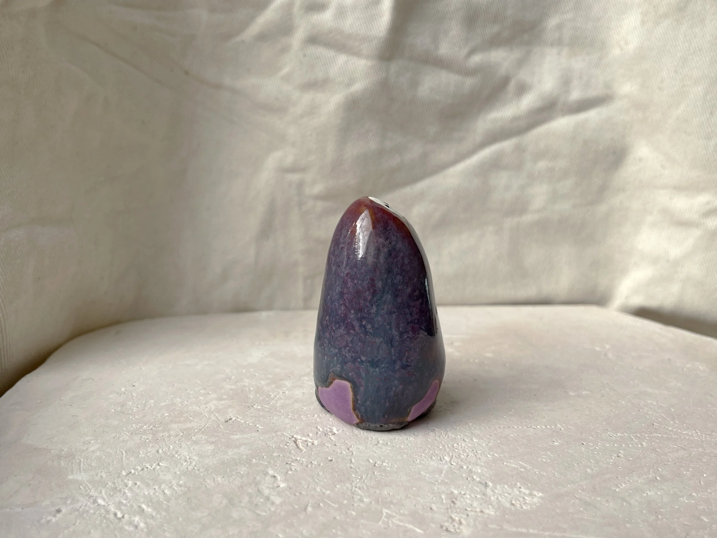 Purple, blue and red handmade figurative ceramic sculpture with glossy drippy floating glaze