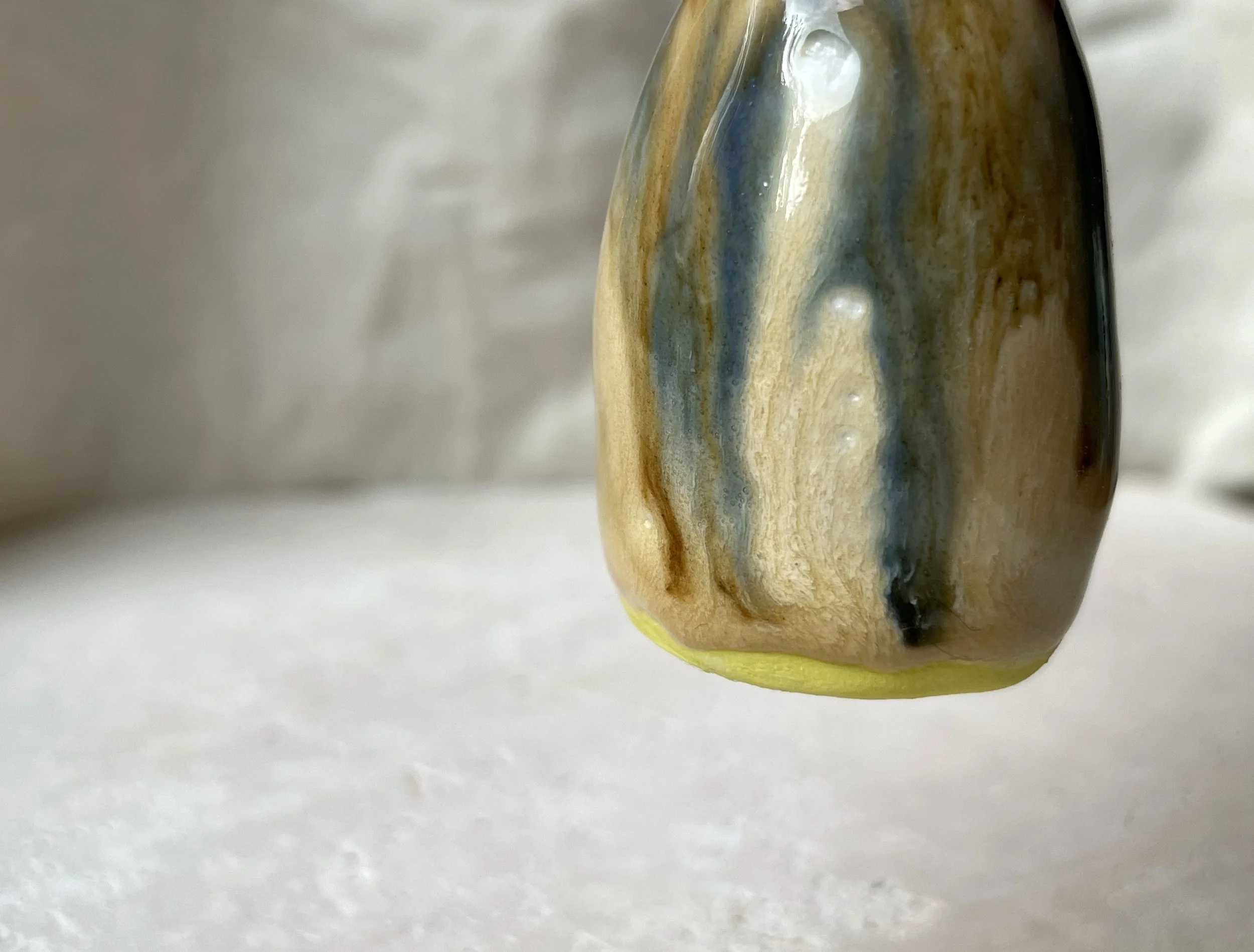 Yellow, brown, blue and cream handmade figurative ceramic sculpture with glossy drippy glaze