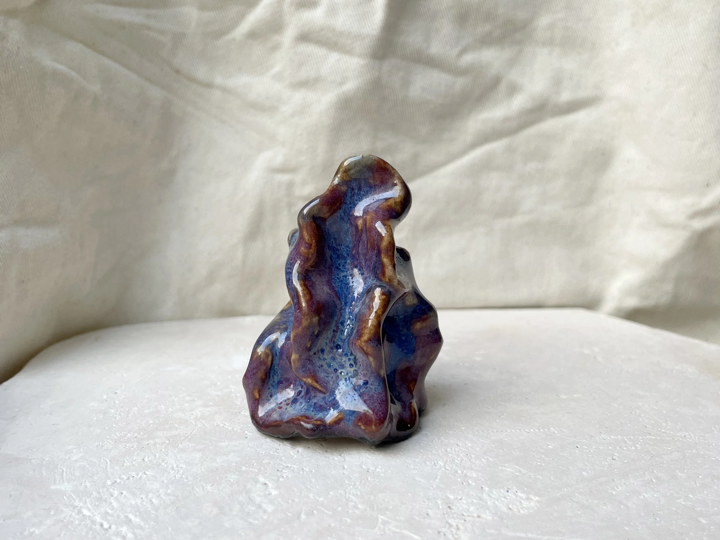 Wavy purple, red and blue handmade figurative ceramic sculpture with glossy floating glaze and underglaze