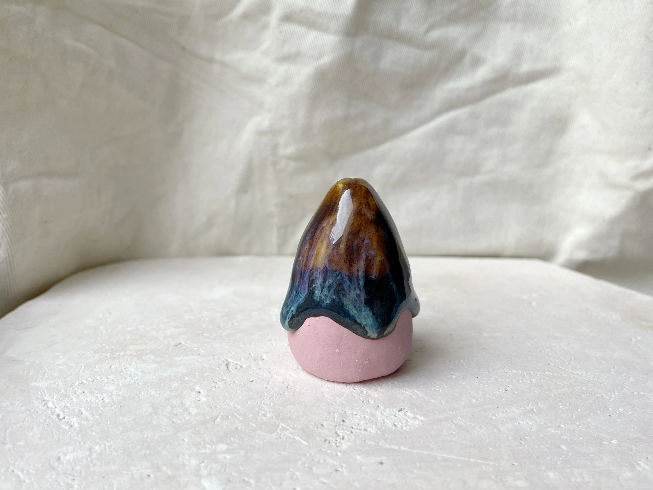 pink, brown and green handmade figurative ceramic sculpture with underglaze and drippy runny glaze