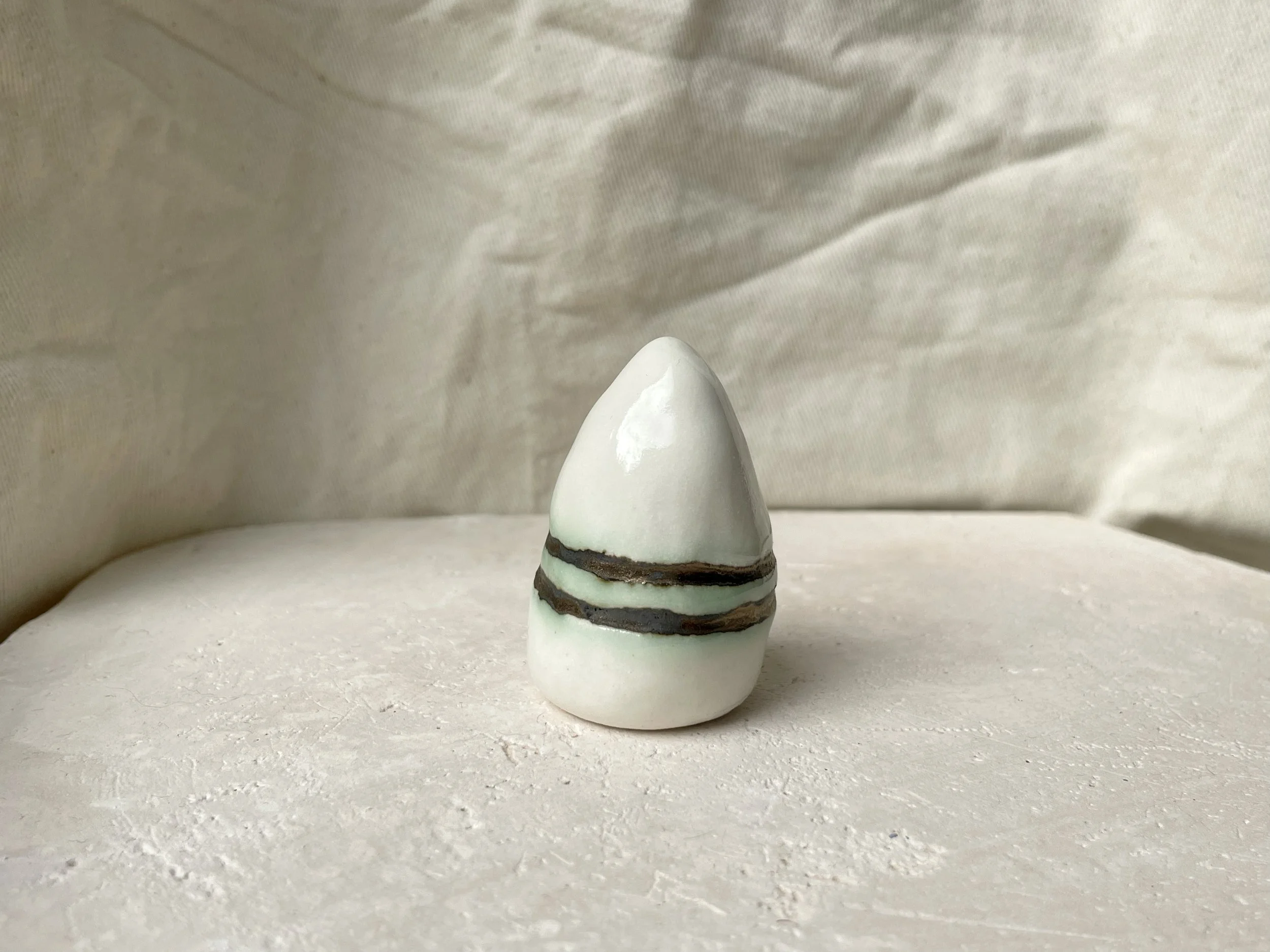 gold and white with hints of green handmade figurative ceramic sculpture with underglaze and glaze