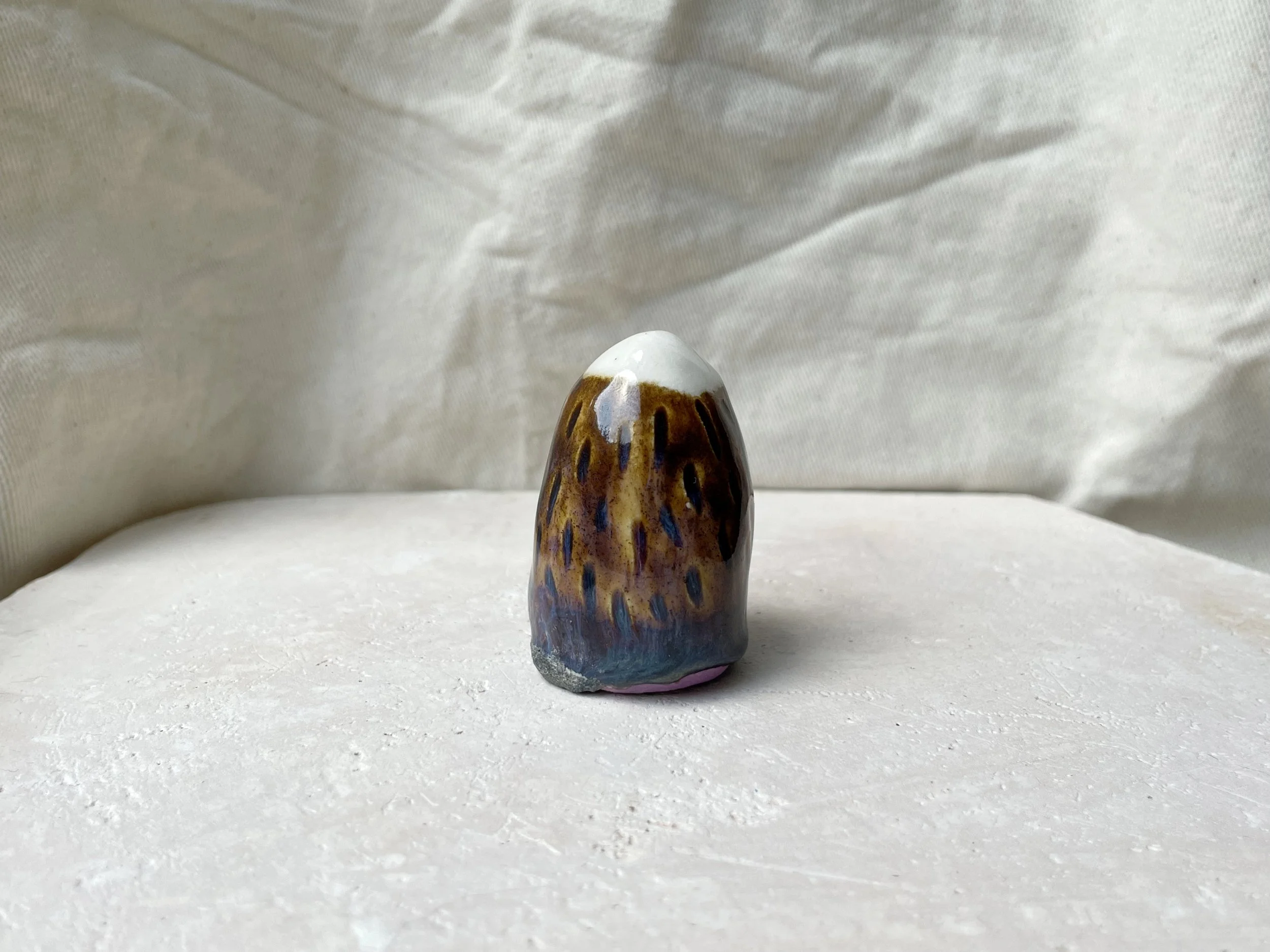 brown, purple and blue handmade figurative ceramic sculpture with underglaze and drippy float glaze