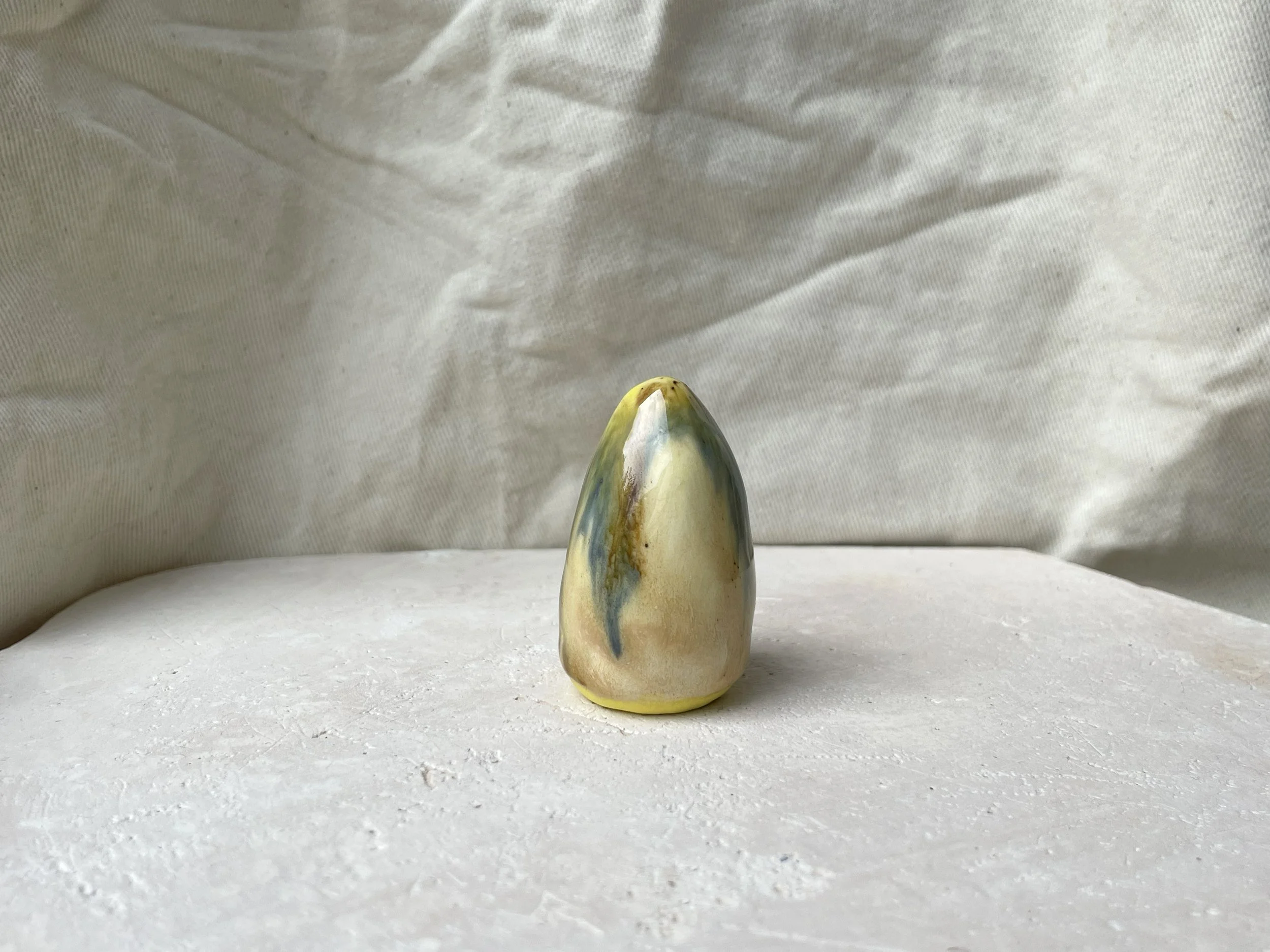 Yellow, blue and brown handmade figurative ceramic sculpture with underglaze and runny glaze