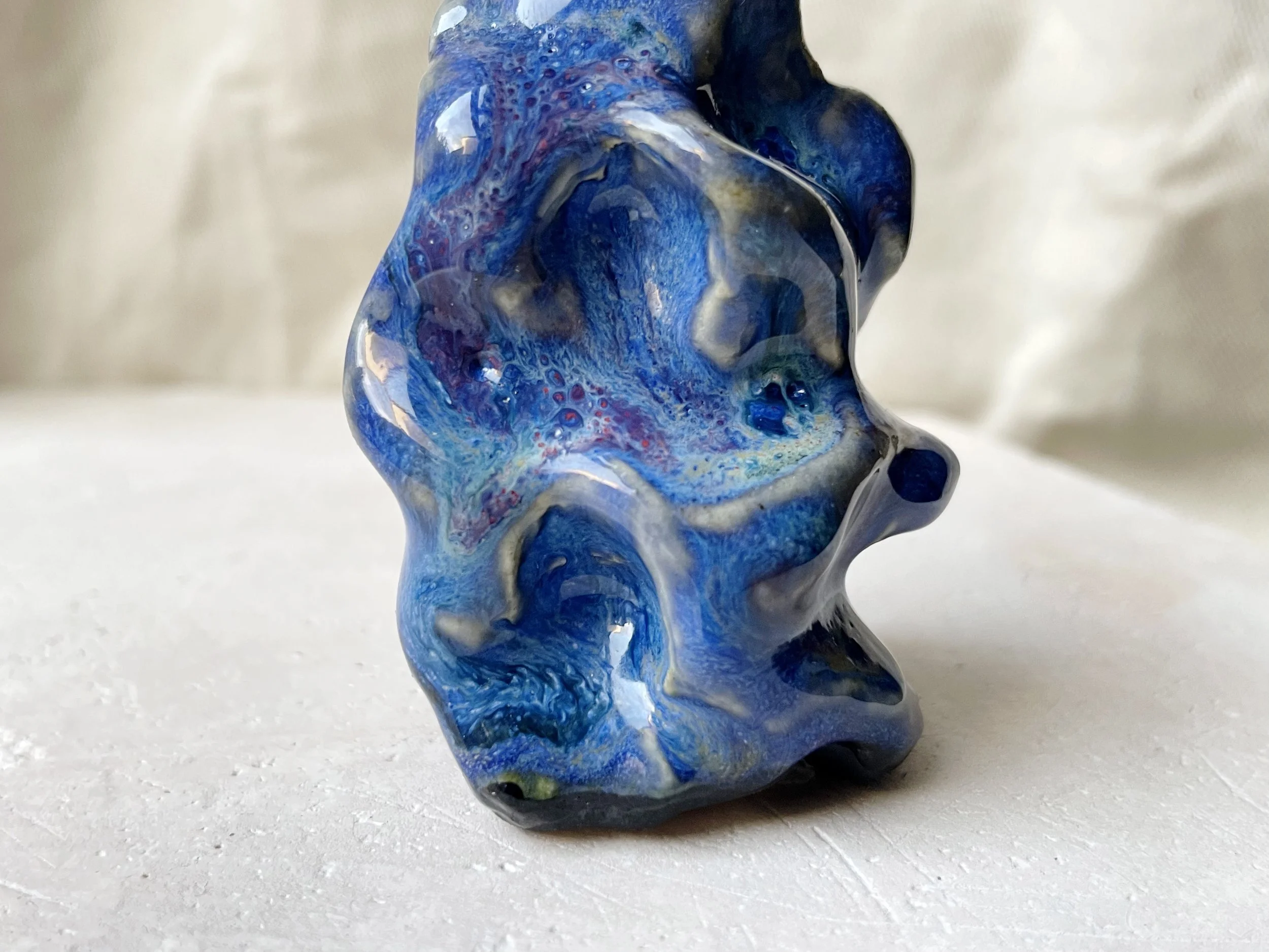Wavy blue and red handmade figurative ceramic sculpture with glossy floating glaze and underglaze
