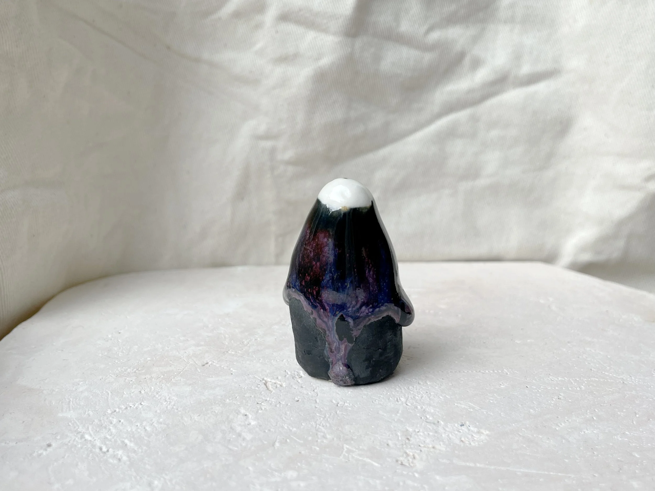 black, lilac and purple drippy handmade figurative ceramic sculpture with glossy floating glaze