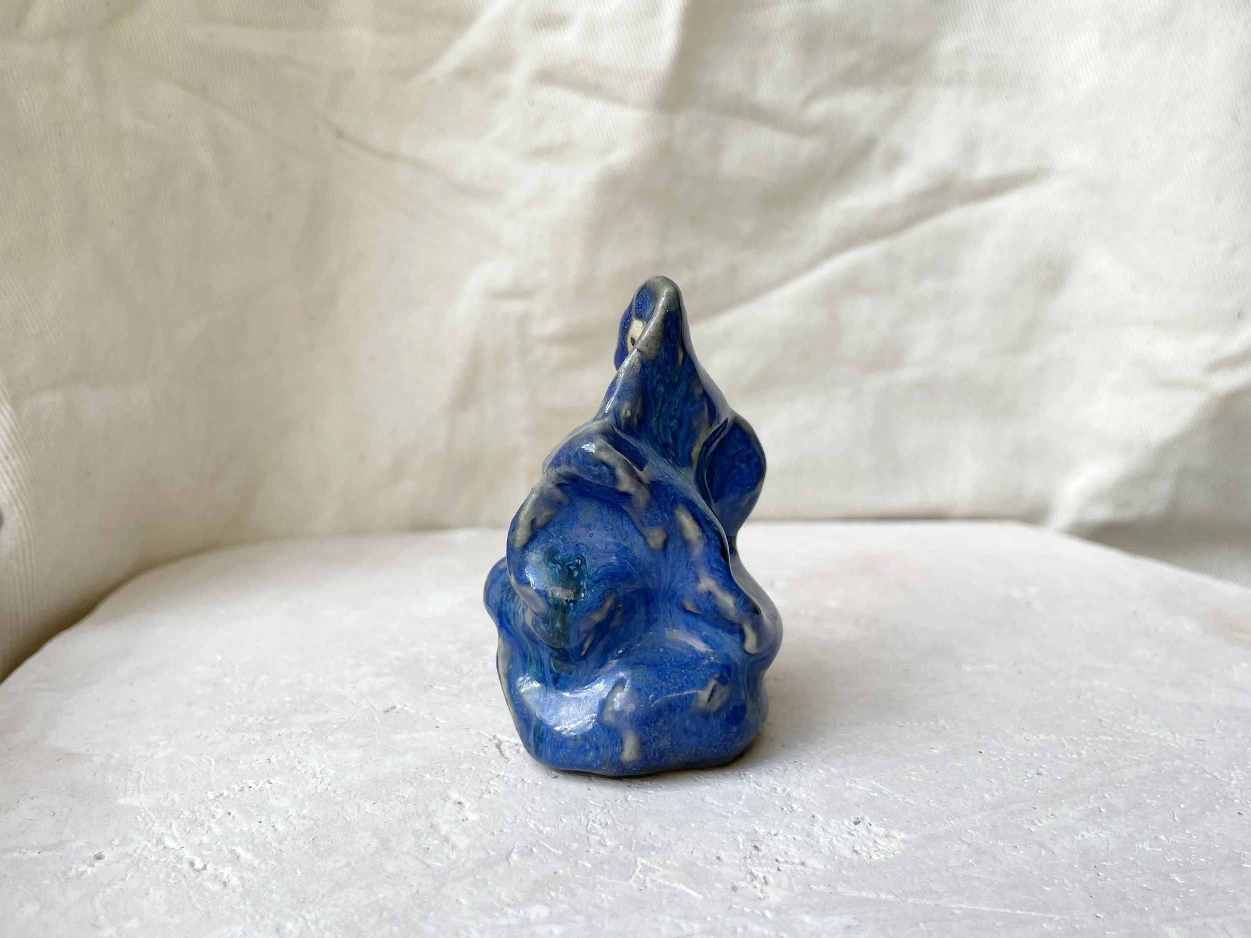 blue wavey handmade figurative ceramic sculpture with runny glaze
