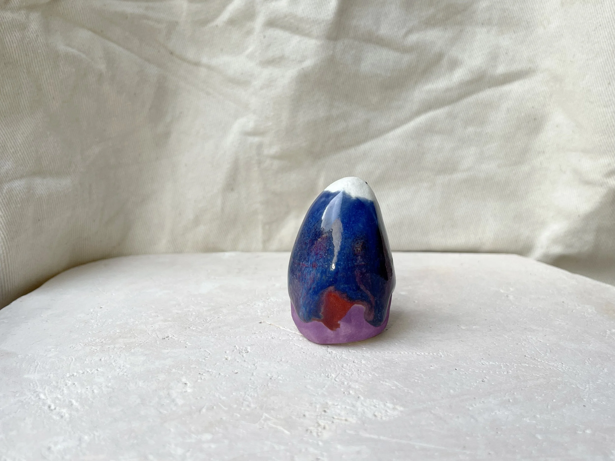 Purple, blue and red handmade figurative ceramic sculpture with glossy drippy glaze