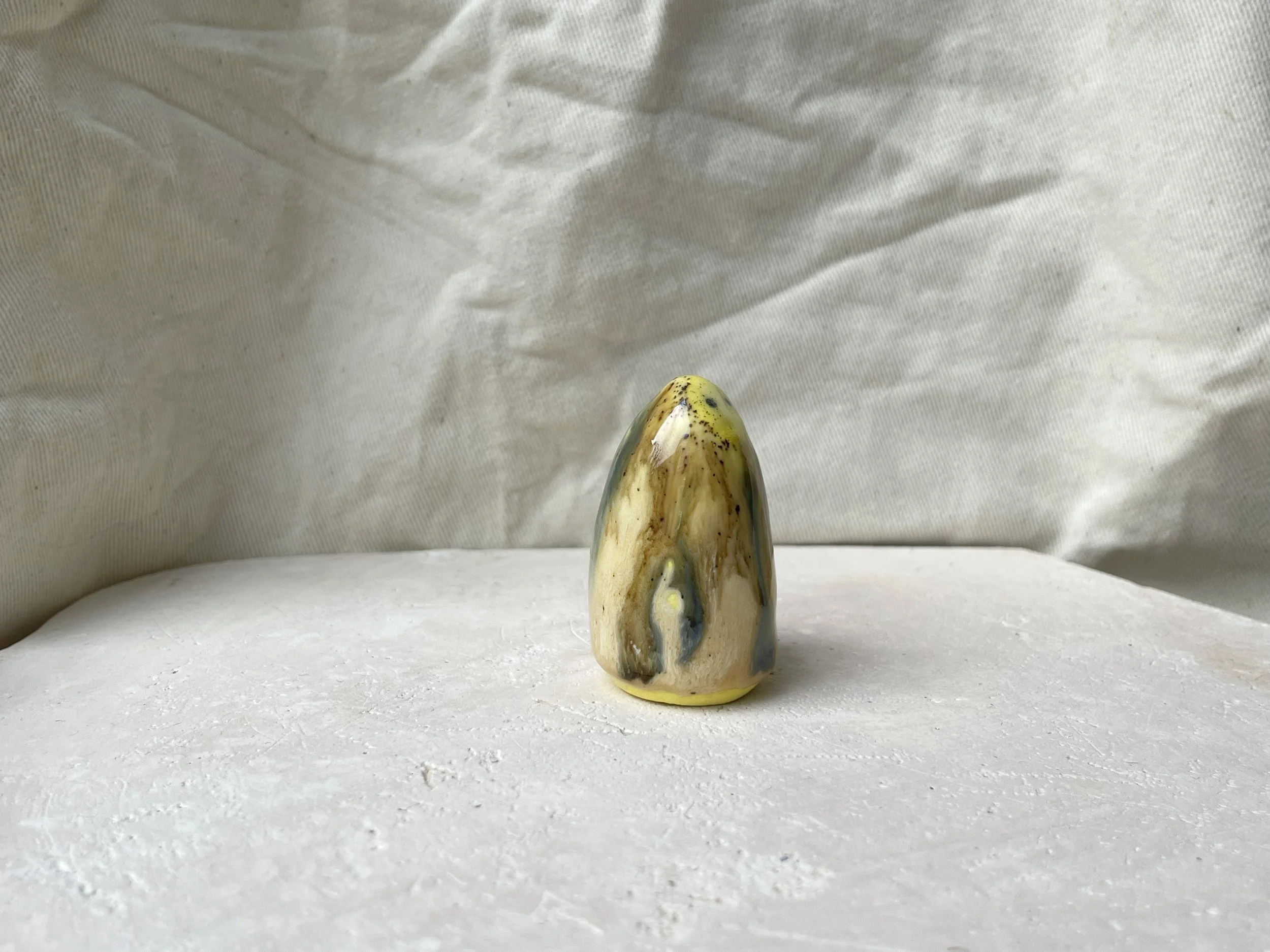 Yellow, blue and brown handmade figurative ceramic sculpture with underglaze and runny glaze