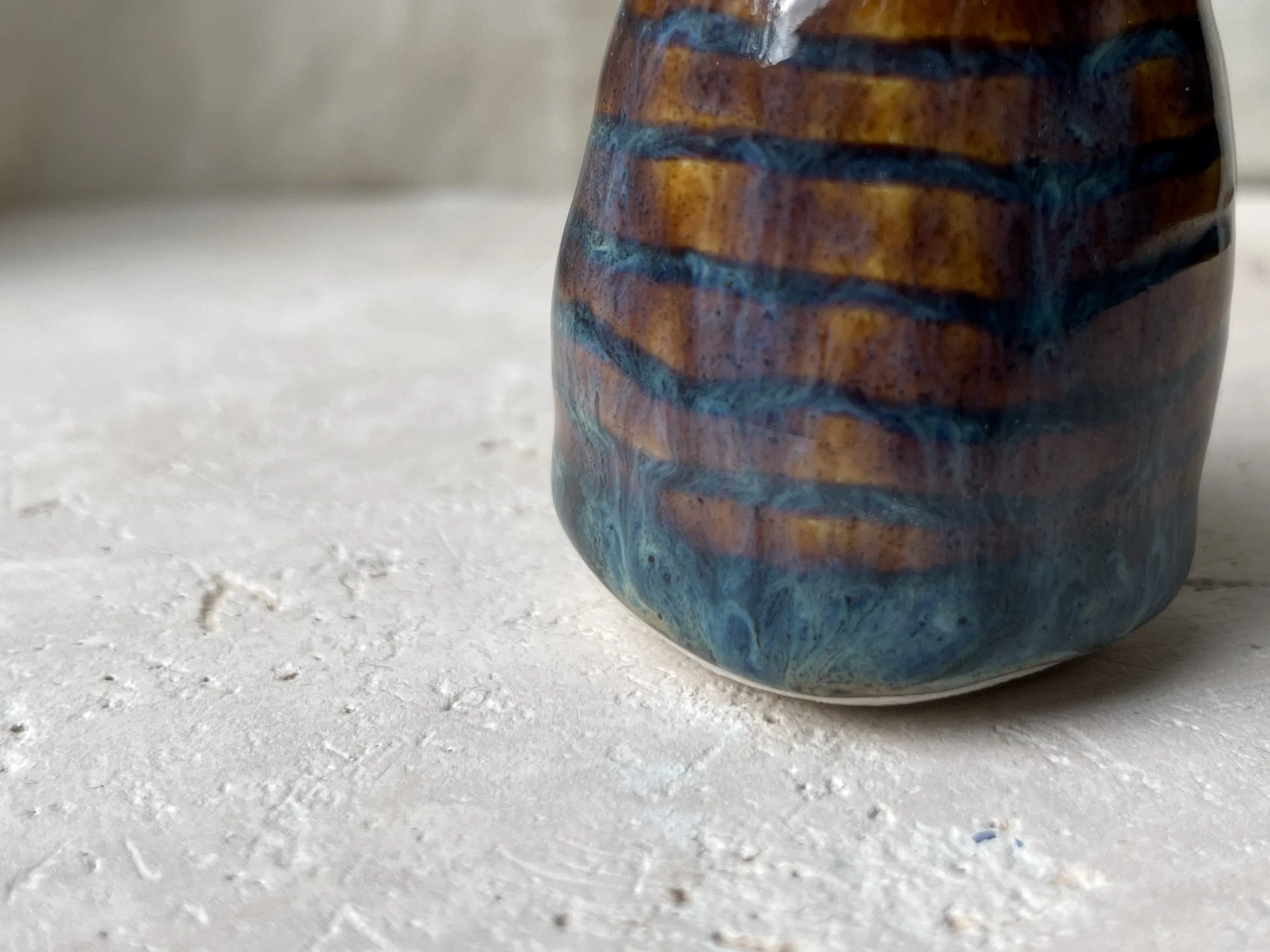 Brown and blue handmade figurative ceramic sculpture with underglaze and runny glaze