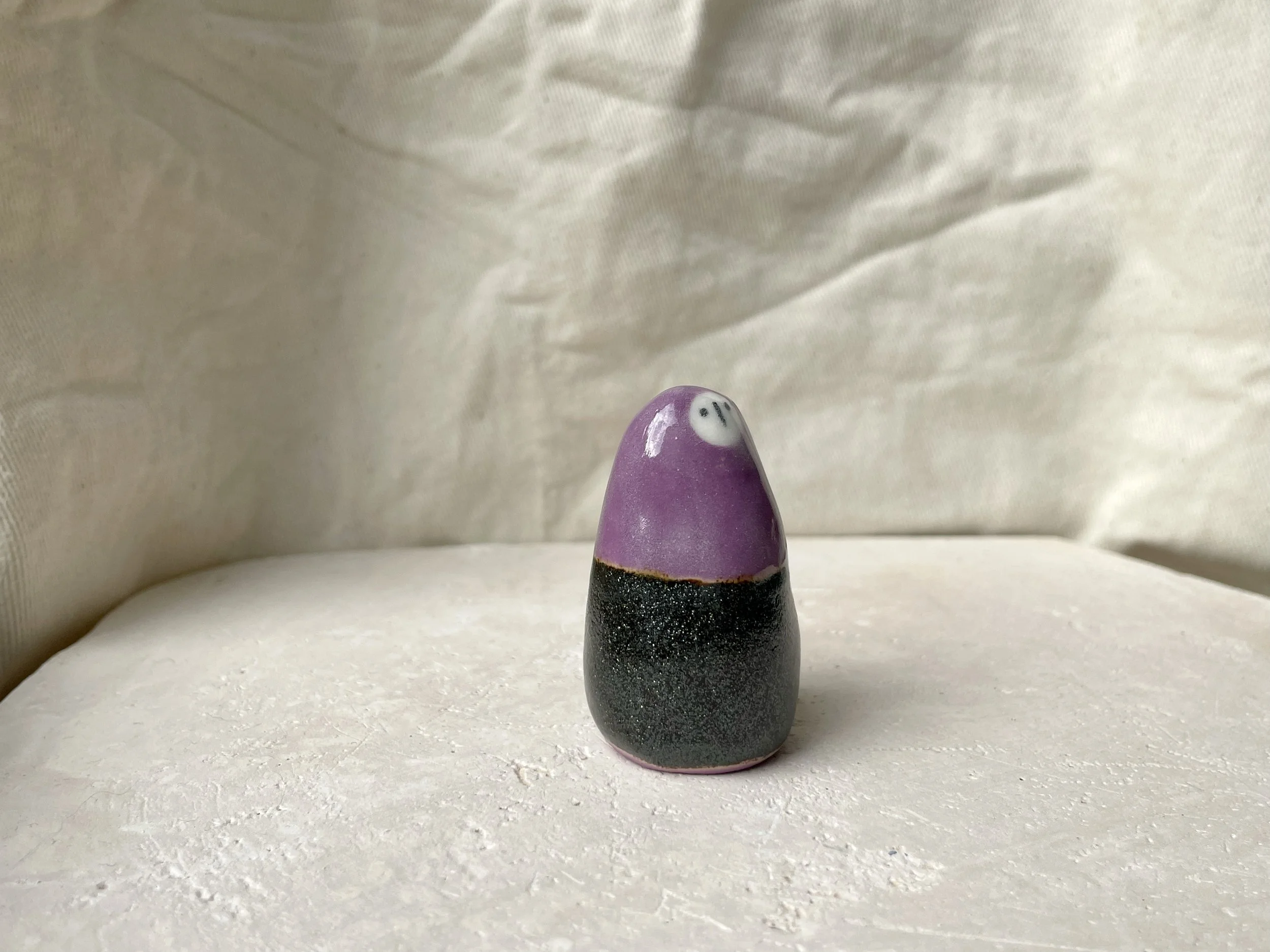Purple and sparkly black handmade figurative ceramic sculpture with underglaze and glaze