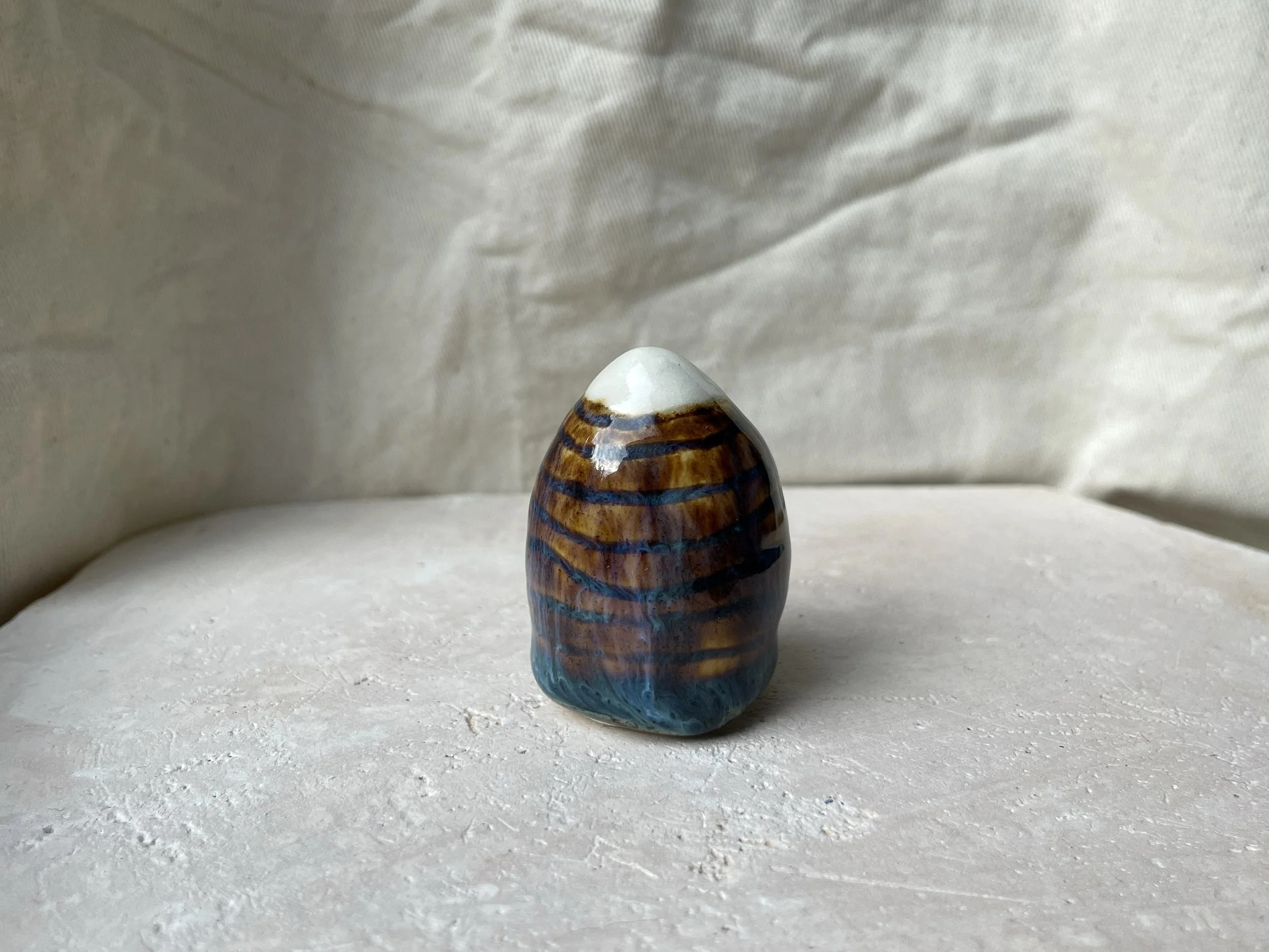 Brown and blue handmade figurative ceramic sculpture with underglaze and runny glaze