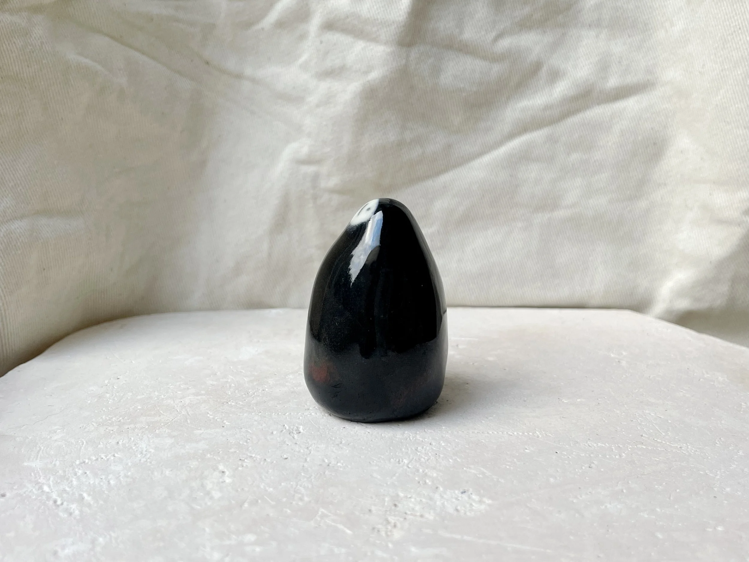 Black red and blue handmade figurative ceramic sculpture with glossy floating glaze