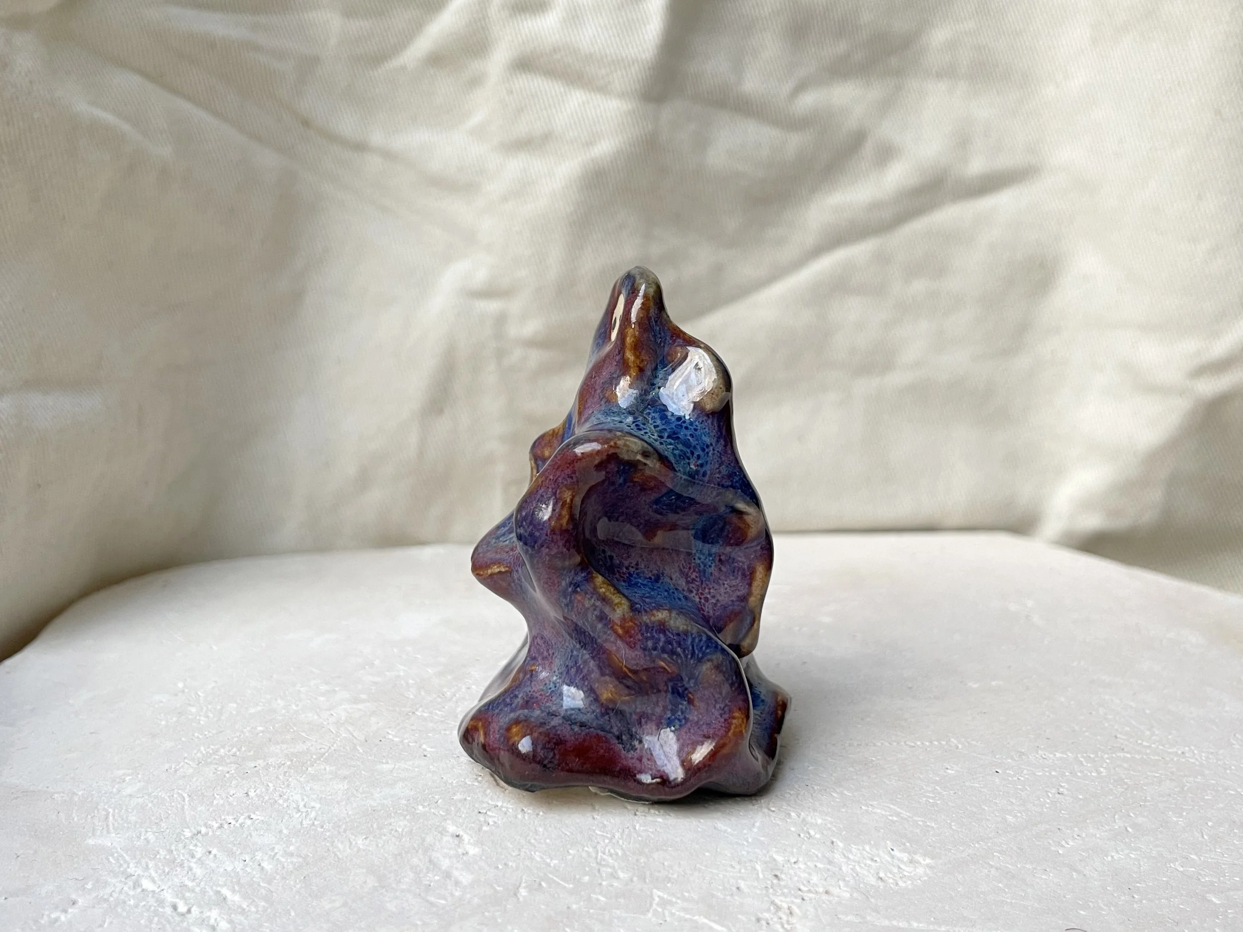 Wavy purple, red and blue handmade figurative ceramic sculpture with glossy floating glaze and underglaze