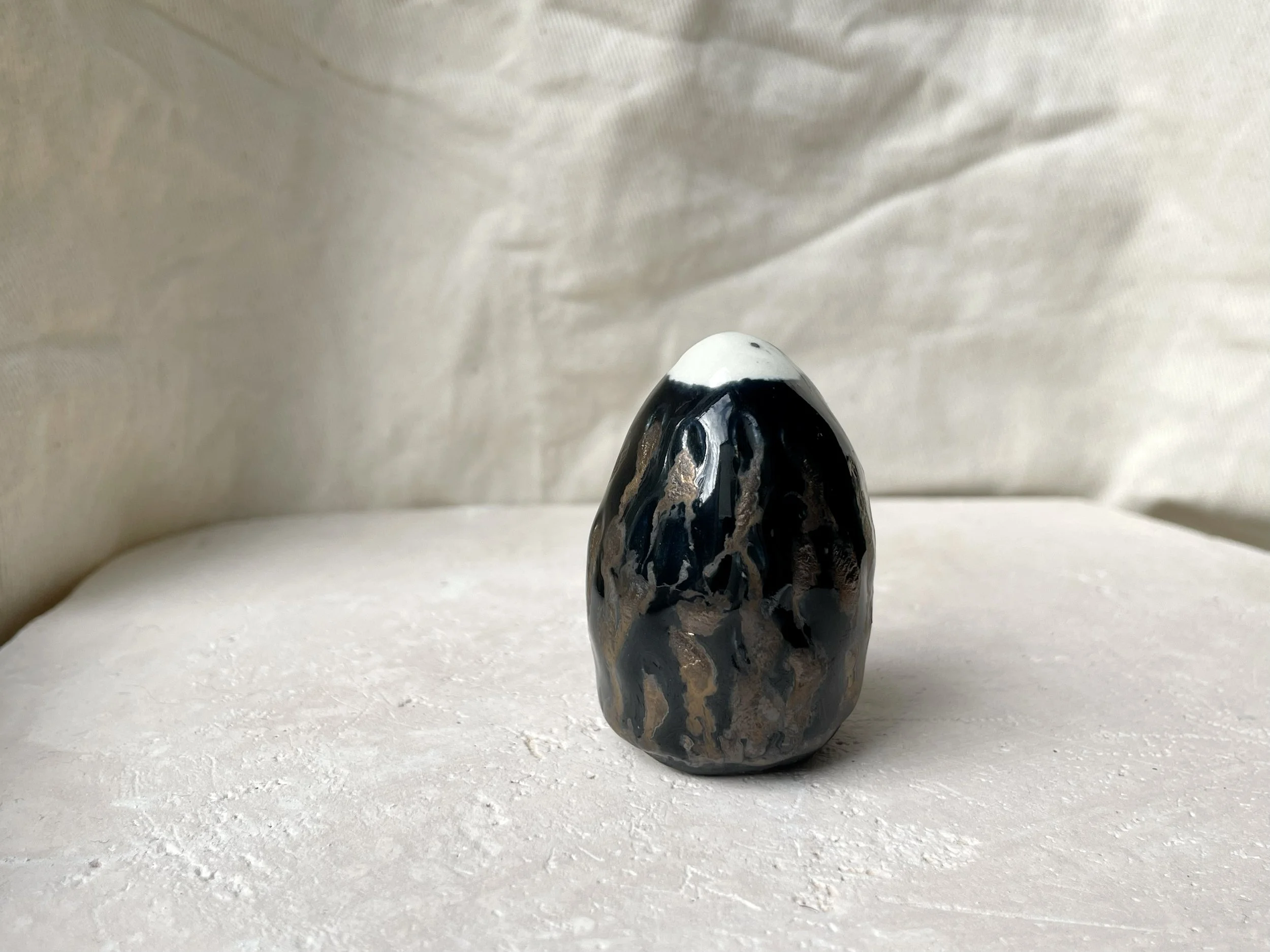 black and metallic gold handmade figurative ceramic sculpture with underglaze and glaze