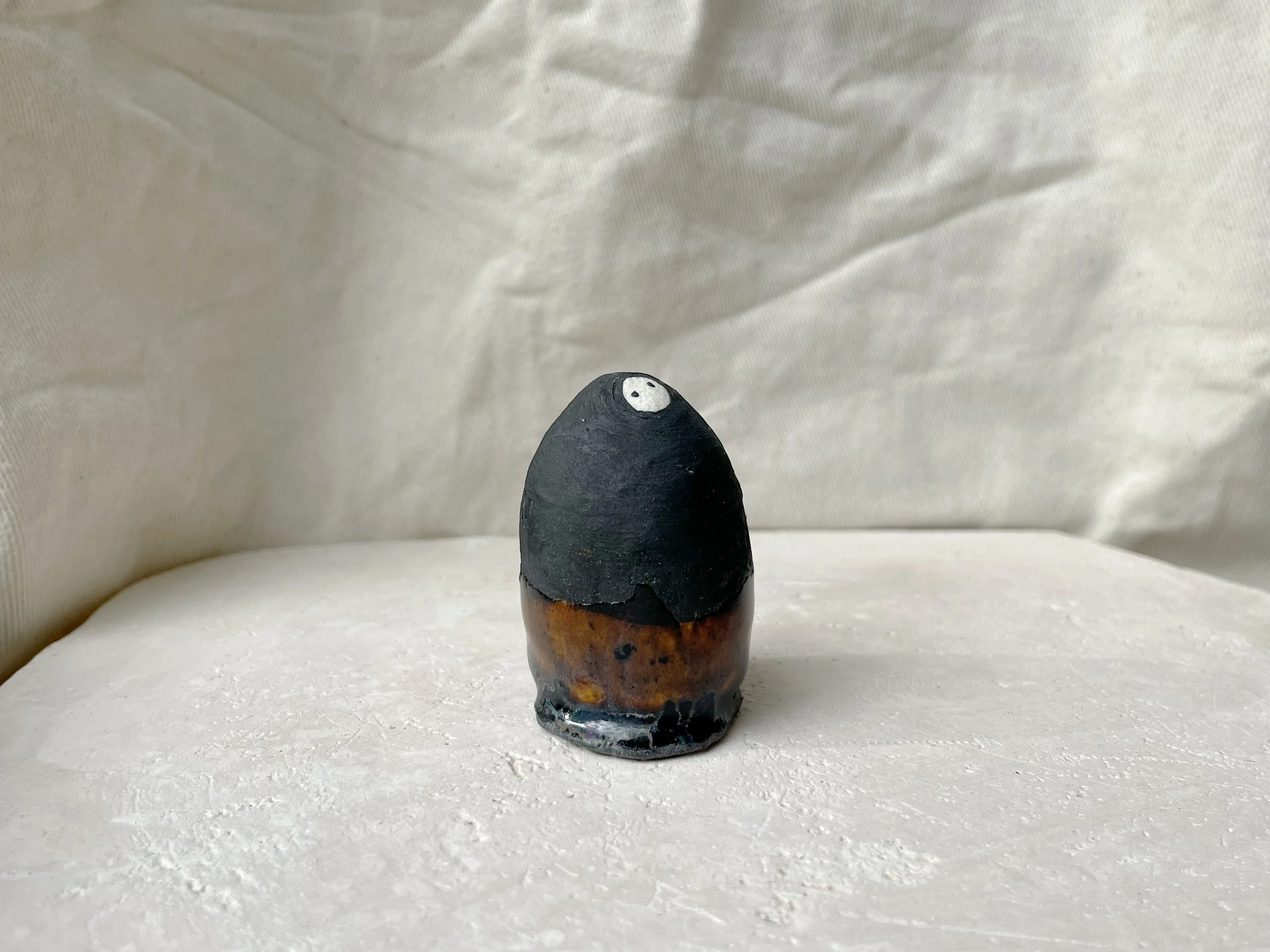 black and brown handmade figurative ceramic sculpture with matt and runny glaze