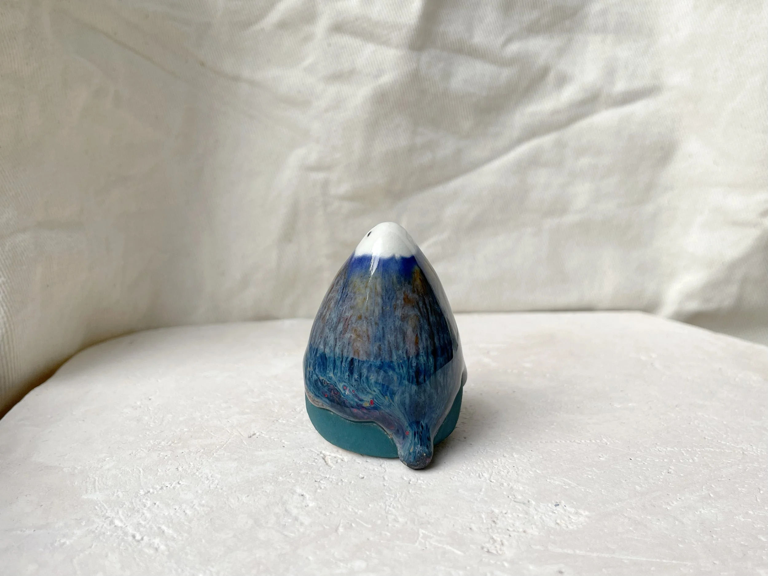 Blue and green handmade figurative ceramic sculpture with underglaze and runny glaze