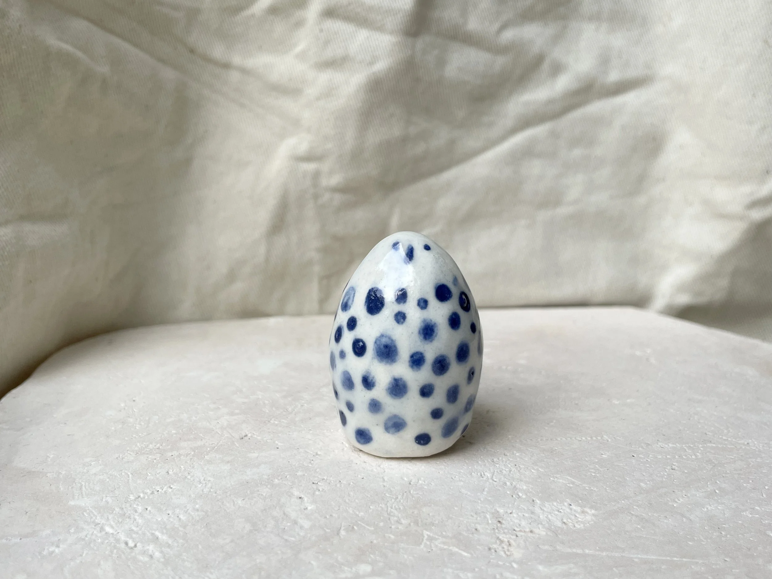 White and blue glossy dotty handmade figurative ceramic sculpture